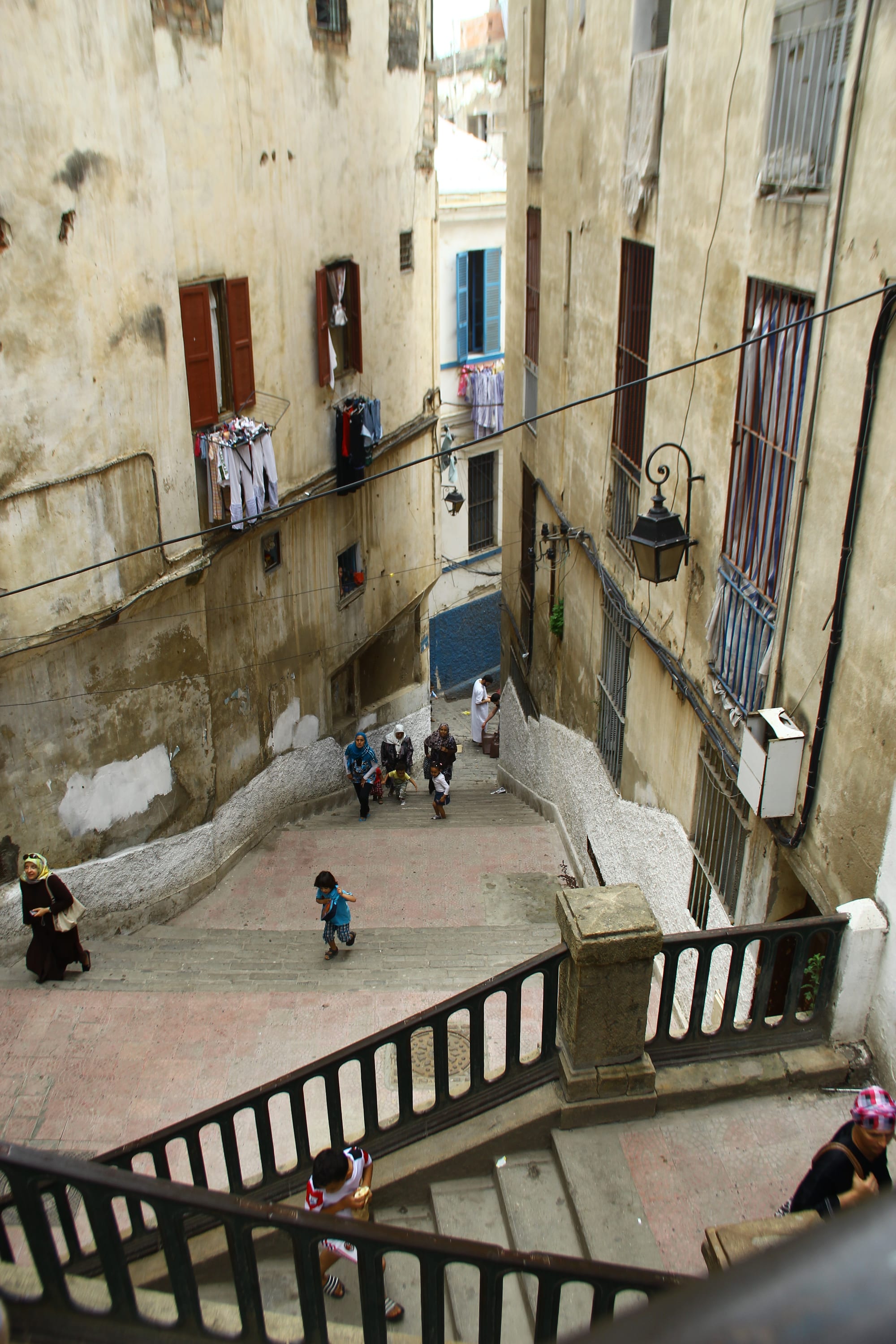 Steep narrow alley of whitewashed houses stepping down a hillside