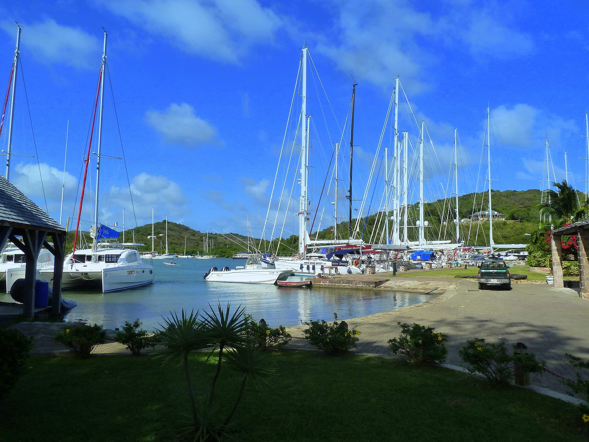 Yachts moored along a stone quay with restored Georgian warehouses behind