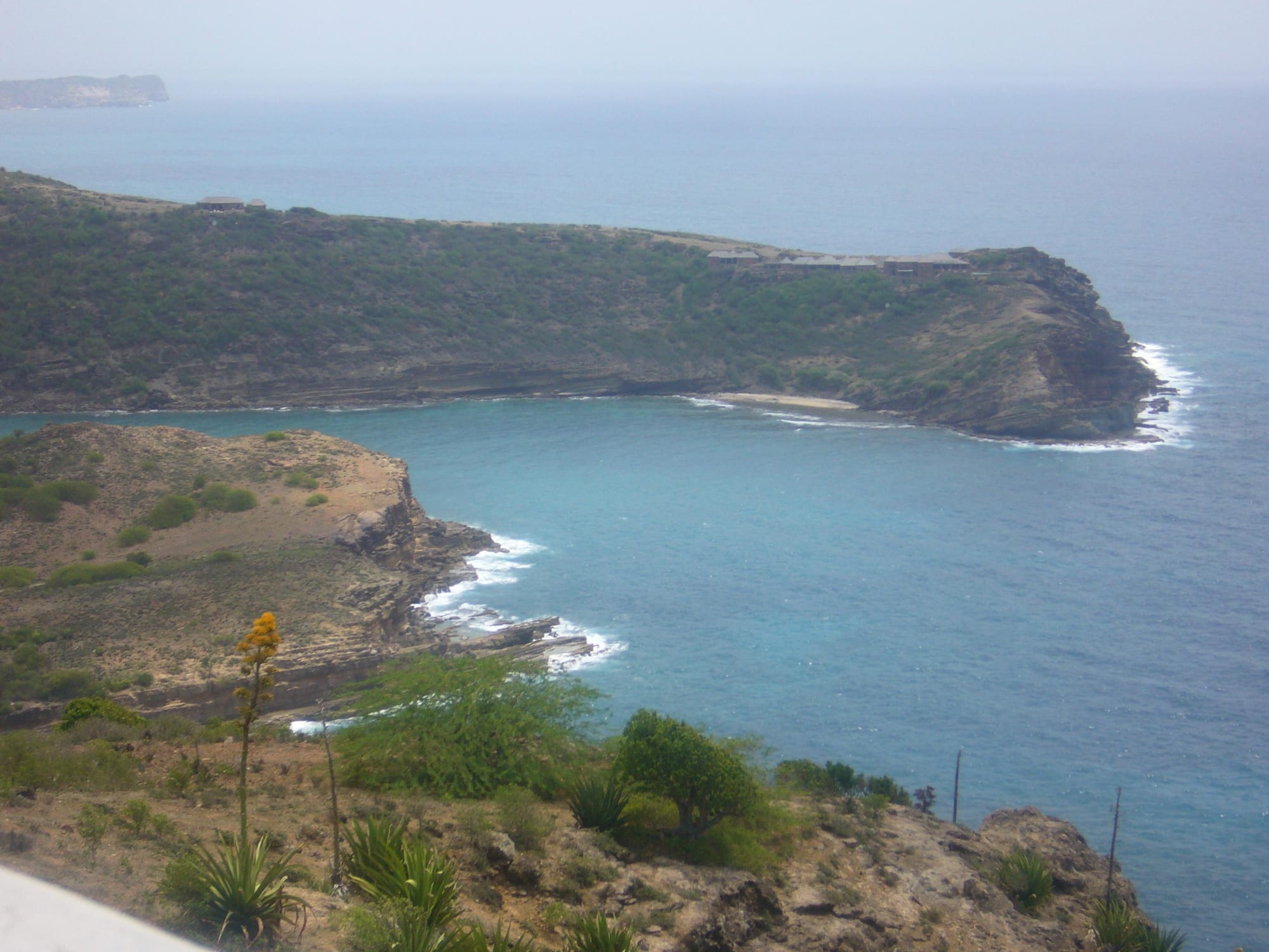 View from a fortified hilltop down over two enclosed harbours ringed by hills