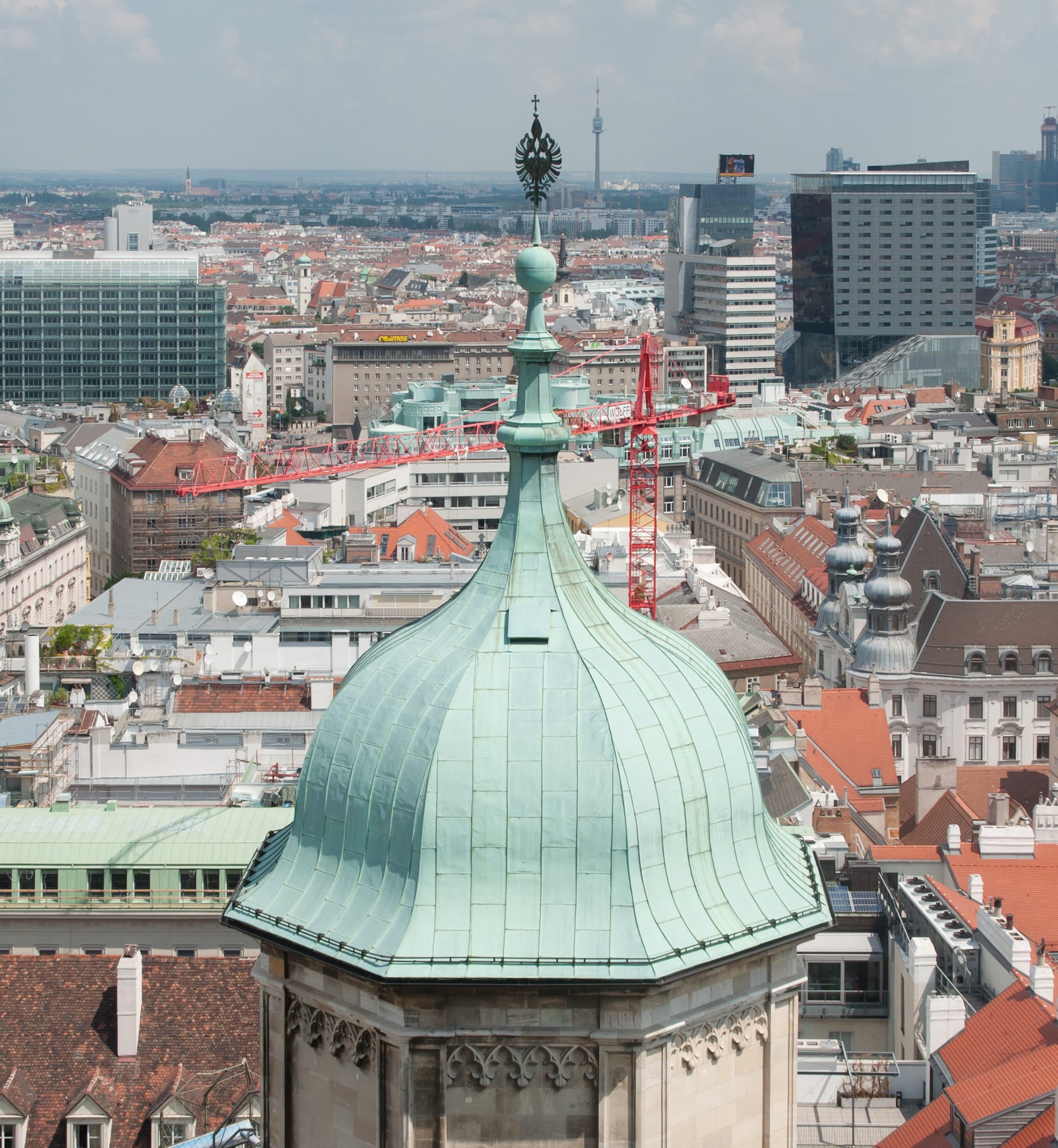 A steep cathedral roof covered in glazed tiles in a bright zigzag chevron pattern
