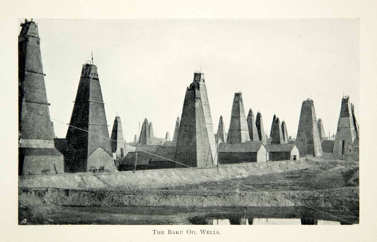 A dense forest of wooden oil derricks crowded together on bare ground, 1903
