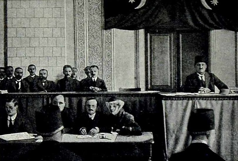 A 1918 photograph of formally dressed delegates seated in rows at the opening session of a parliament