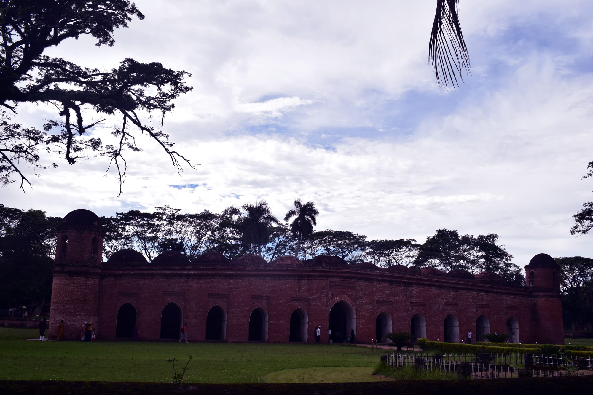 A long low mosque with dozens of small domes and tapering corner towers