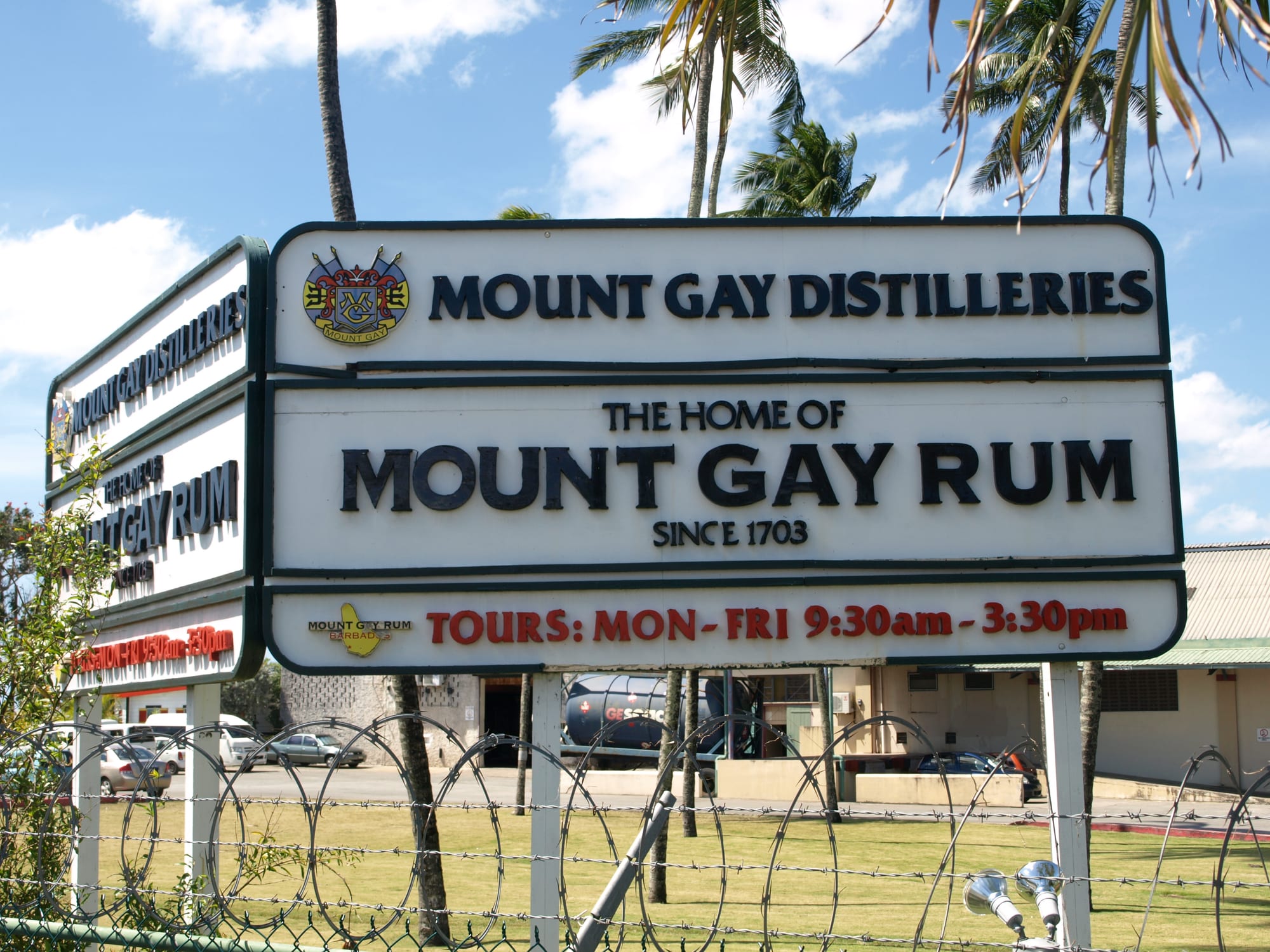 A large sign reading Mount Gay Rum in front of an industrial building