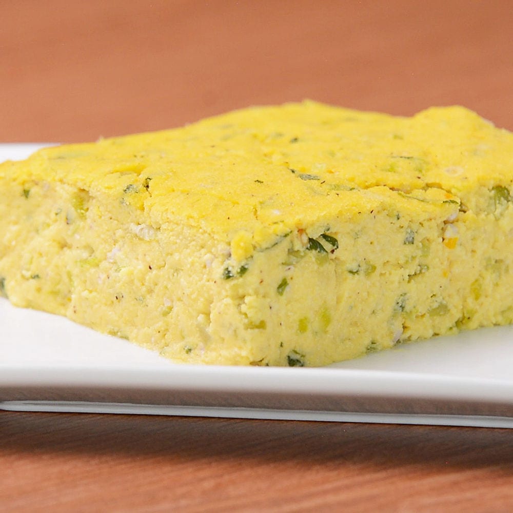 A mound of pale yellow cornmeal paste on a plate