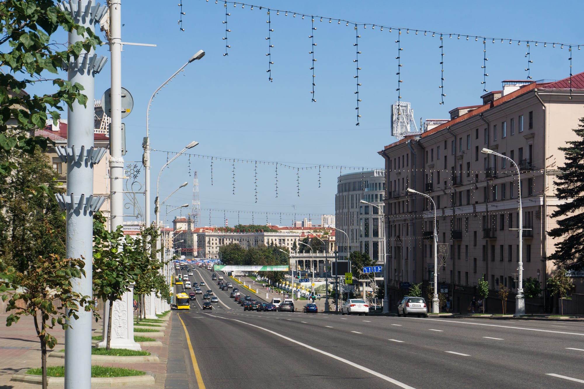 A very wide boulevard lined with monumental pale neoclassical apartment blocks