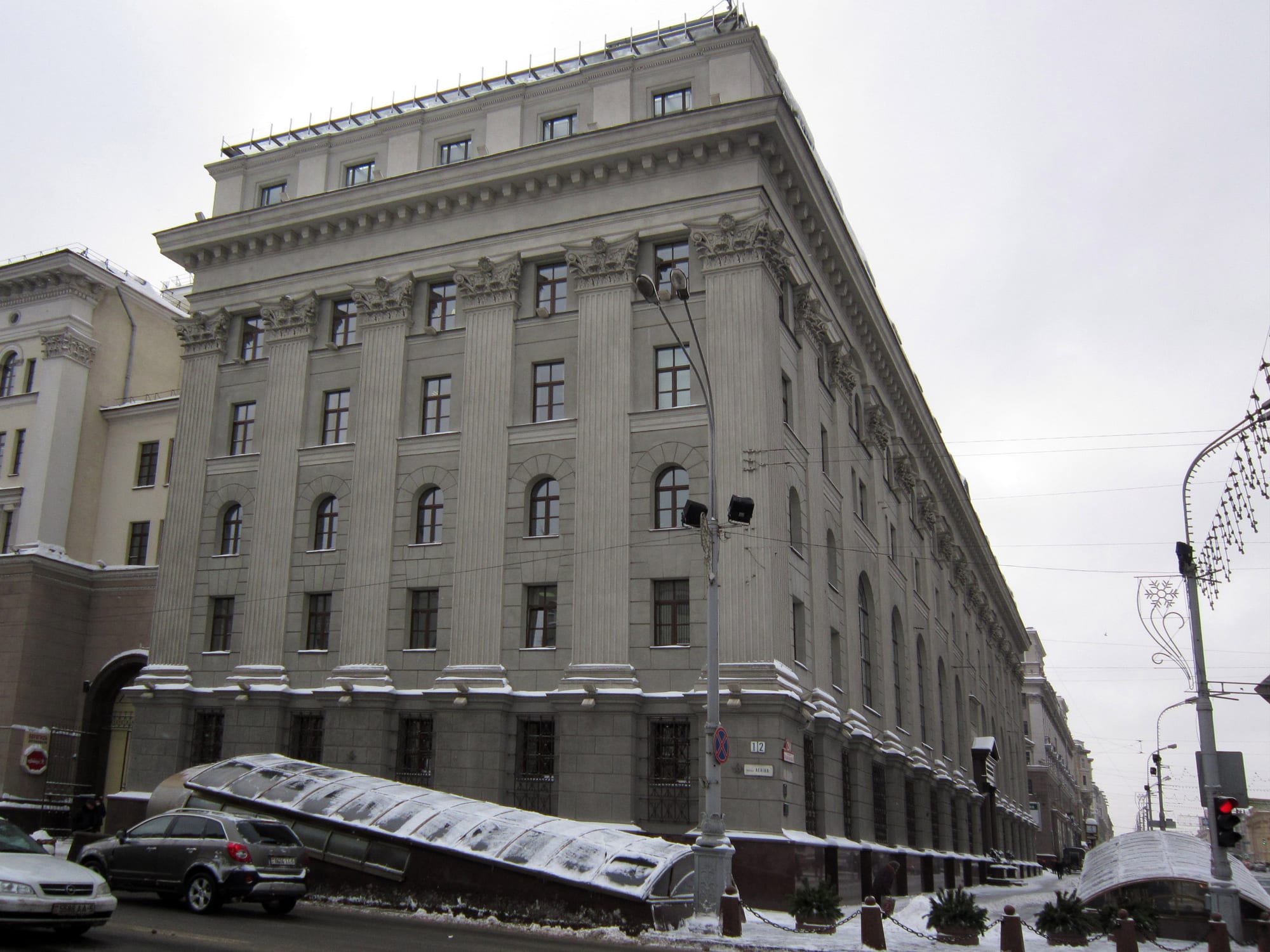 A monumental avenue of symmetrical neoclassical apartment blocks with a Lenin statue in front of a government building