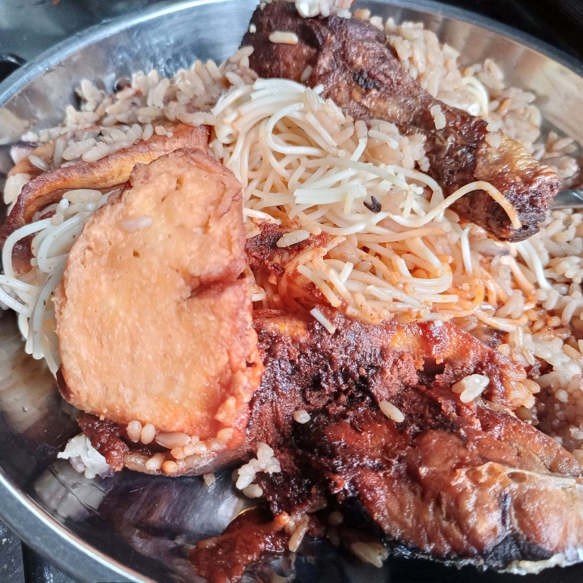 A plate of reddish-brown rice cooked with beans