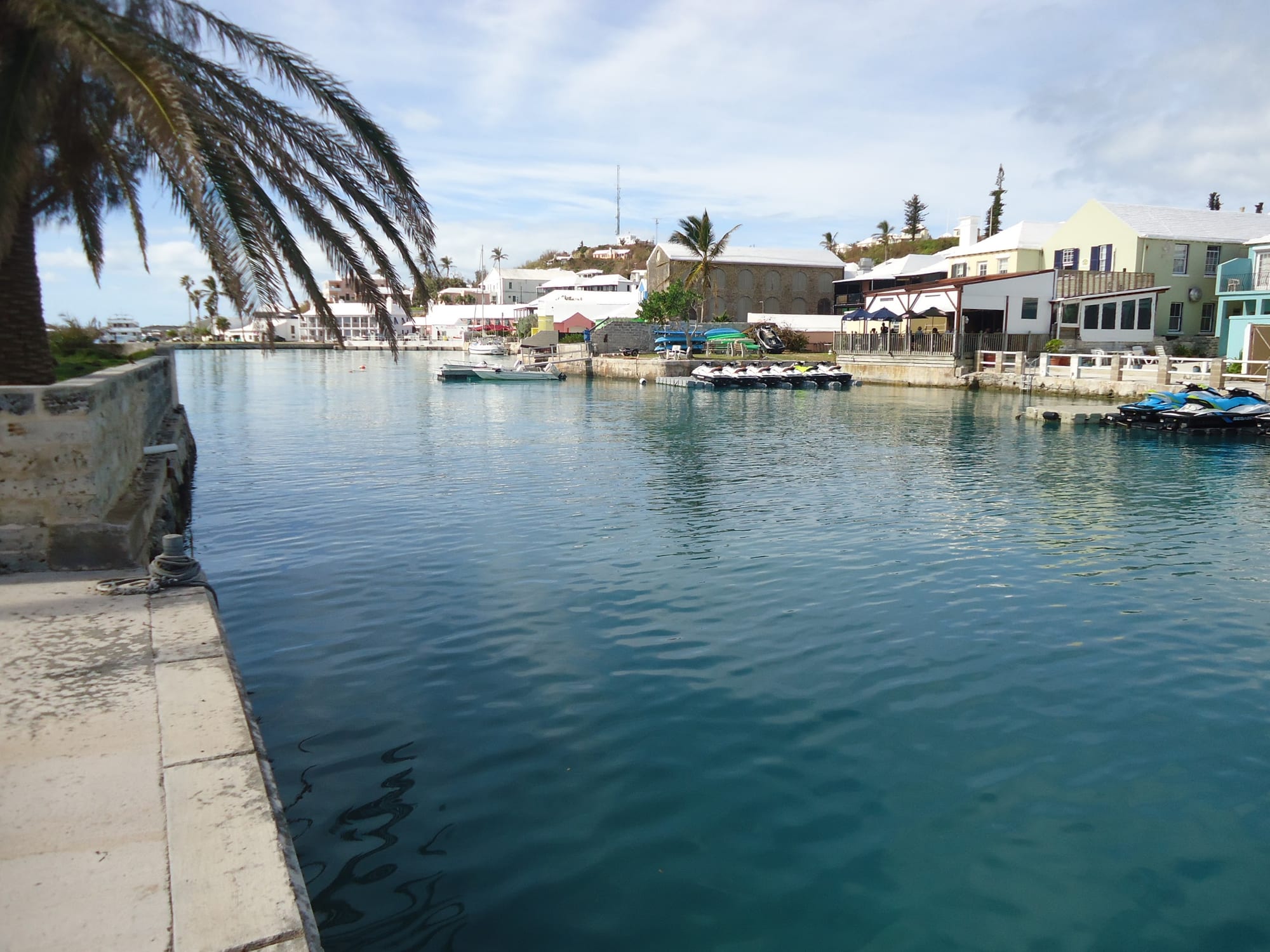 A compact old town of pastel roofs around a sheltered harbour full of boats