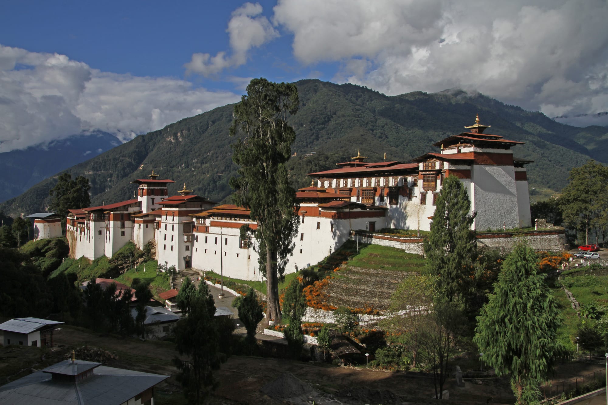 A sprawling white fortress-monastery of many courtyards and towers strung along a high ridge