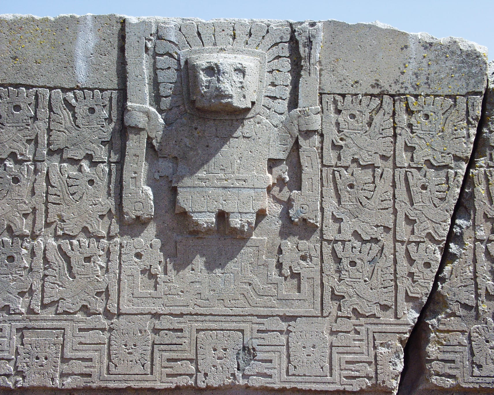 A monolithic stone gateway carved from a single block, with a relief figure above the opening