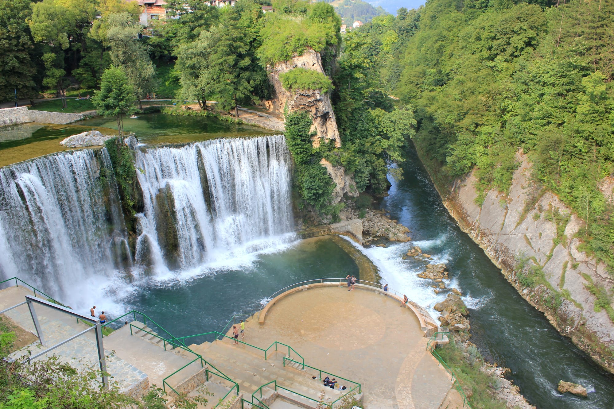 A wide waterfall dropping about 20 metres directly beside the houses of a small town