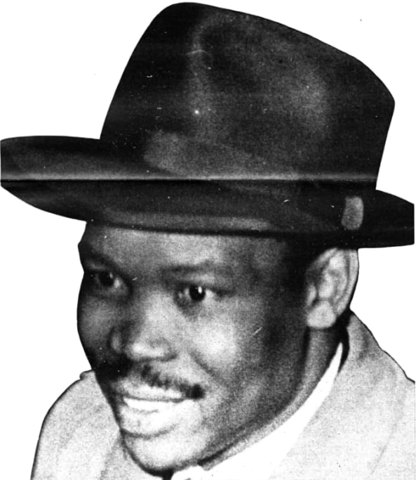 A 1961 photographic portrait of Seretse Khama in a suit and tie, looking to the side