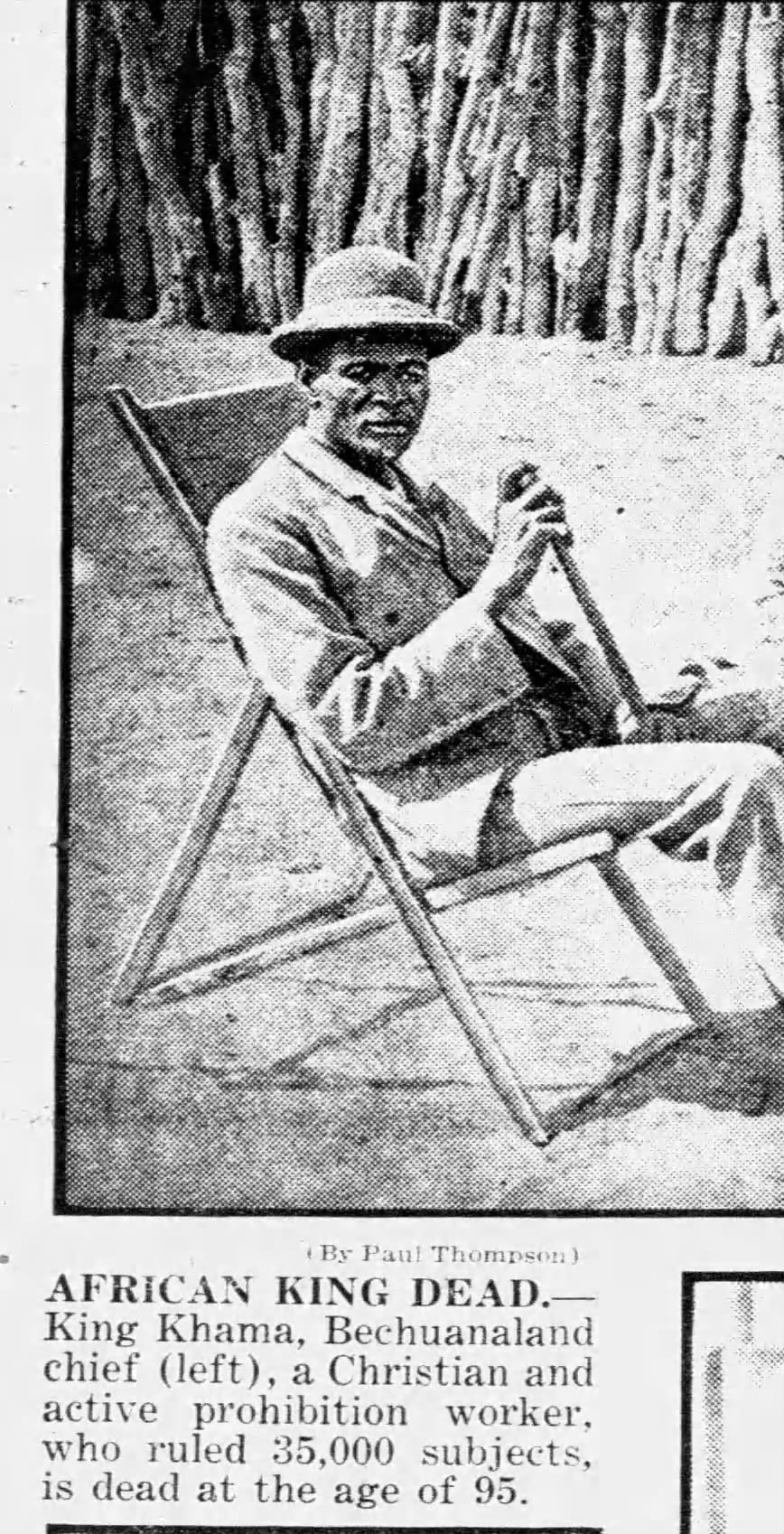 A formal 19th-century studio photograph of an African king in a dark Victorian suit and cloak
