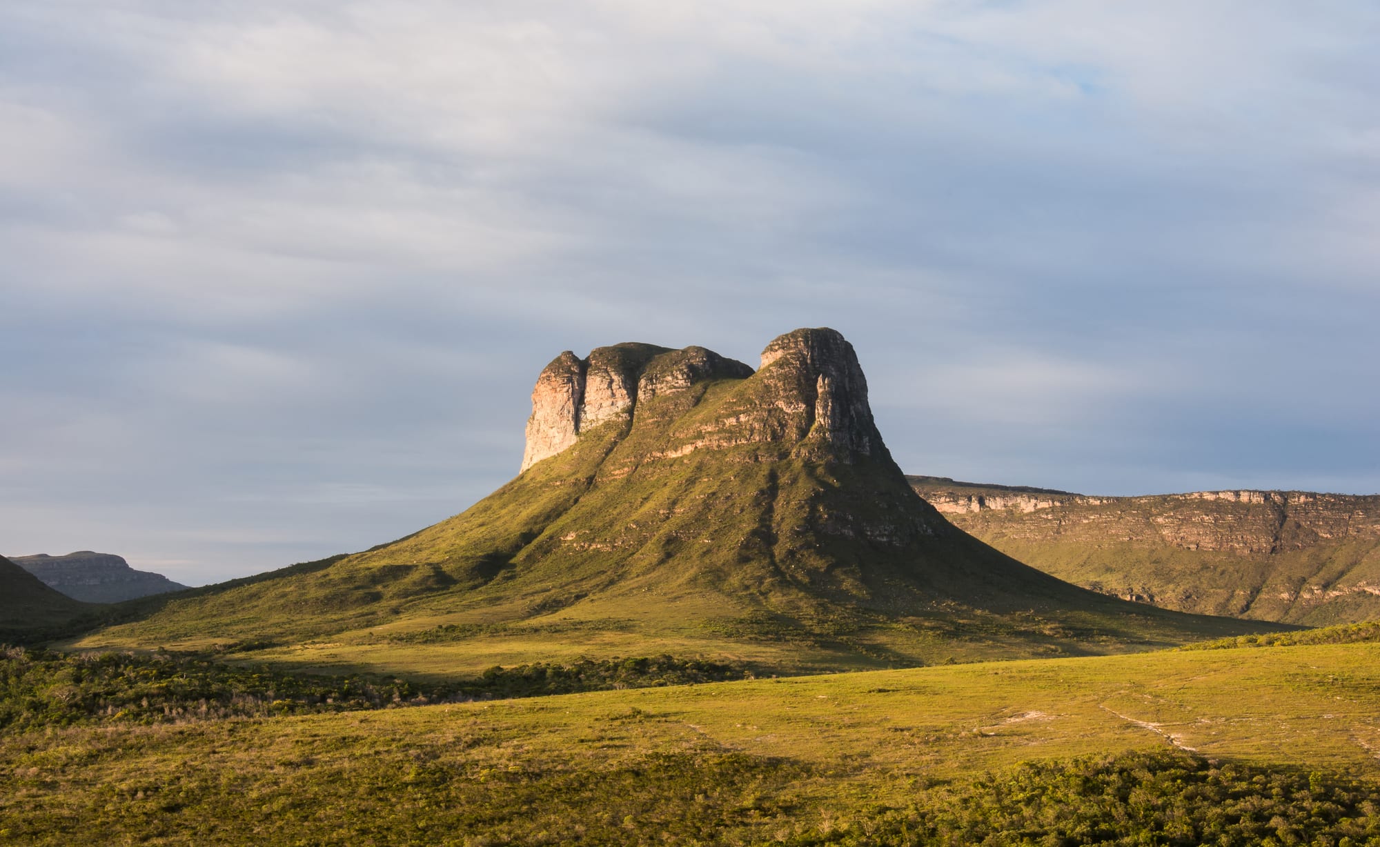 Flat-topped table mountains and deep green valleys receding into haze
