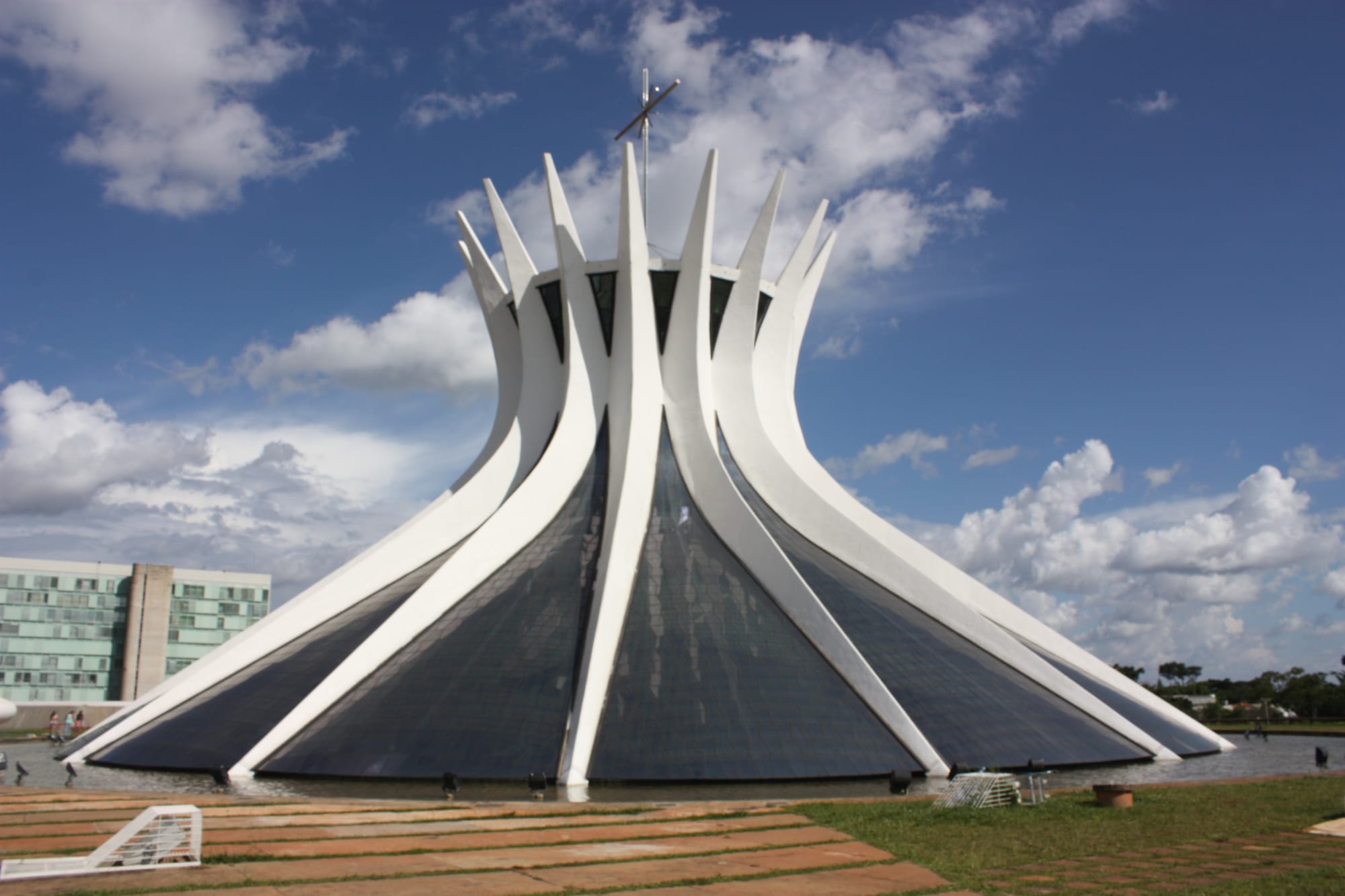 A circular white cathedral formed of curved concrete ribs sweeping up to a crown, with glass between