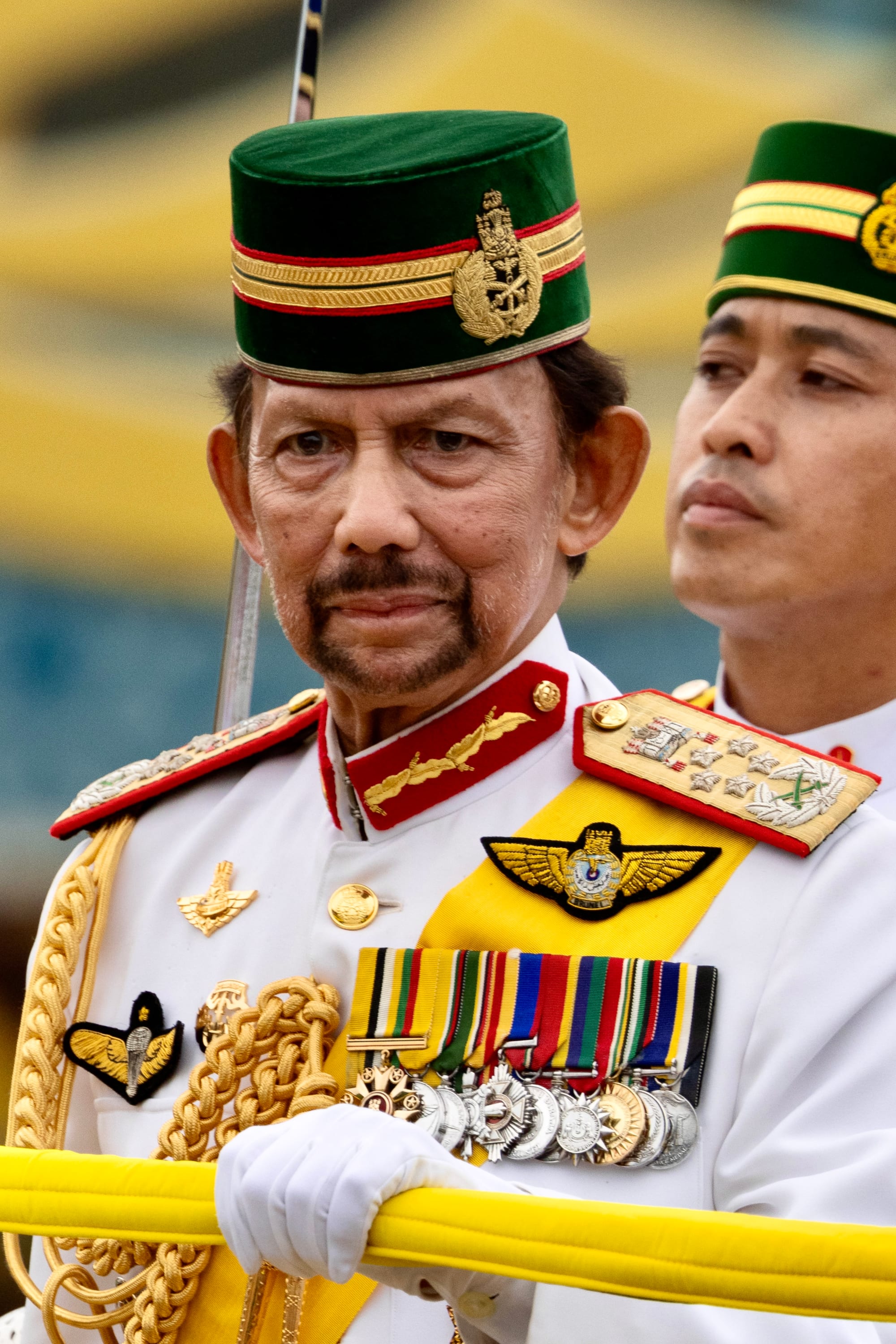Sultan Hassanal Bolkiah in a formal military uniform with medals and a gold ceremonial dagger