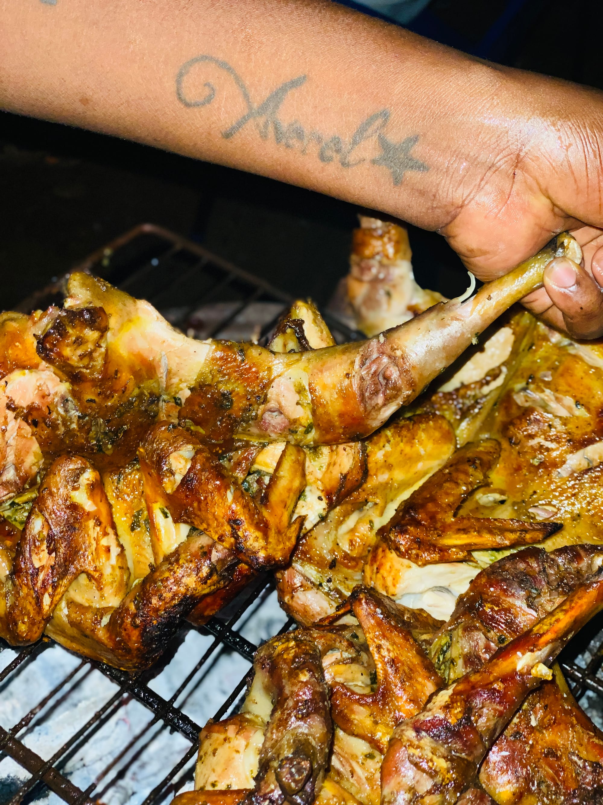 Pieces of grilled, charred chicken on a plate