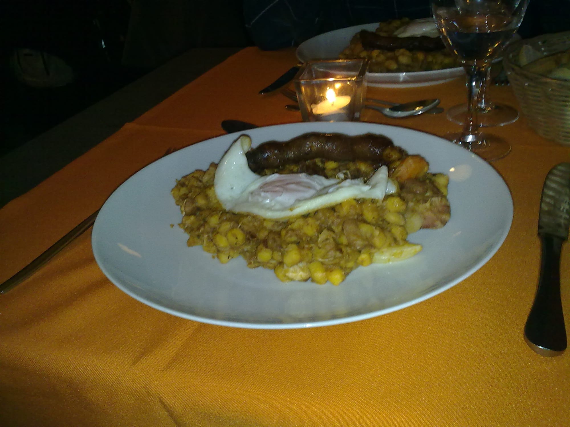A plate of fried corn and bean stew with visible browned, crisped edges
