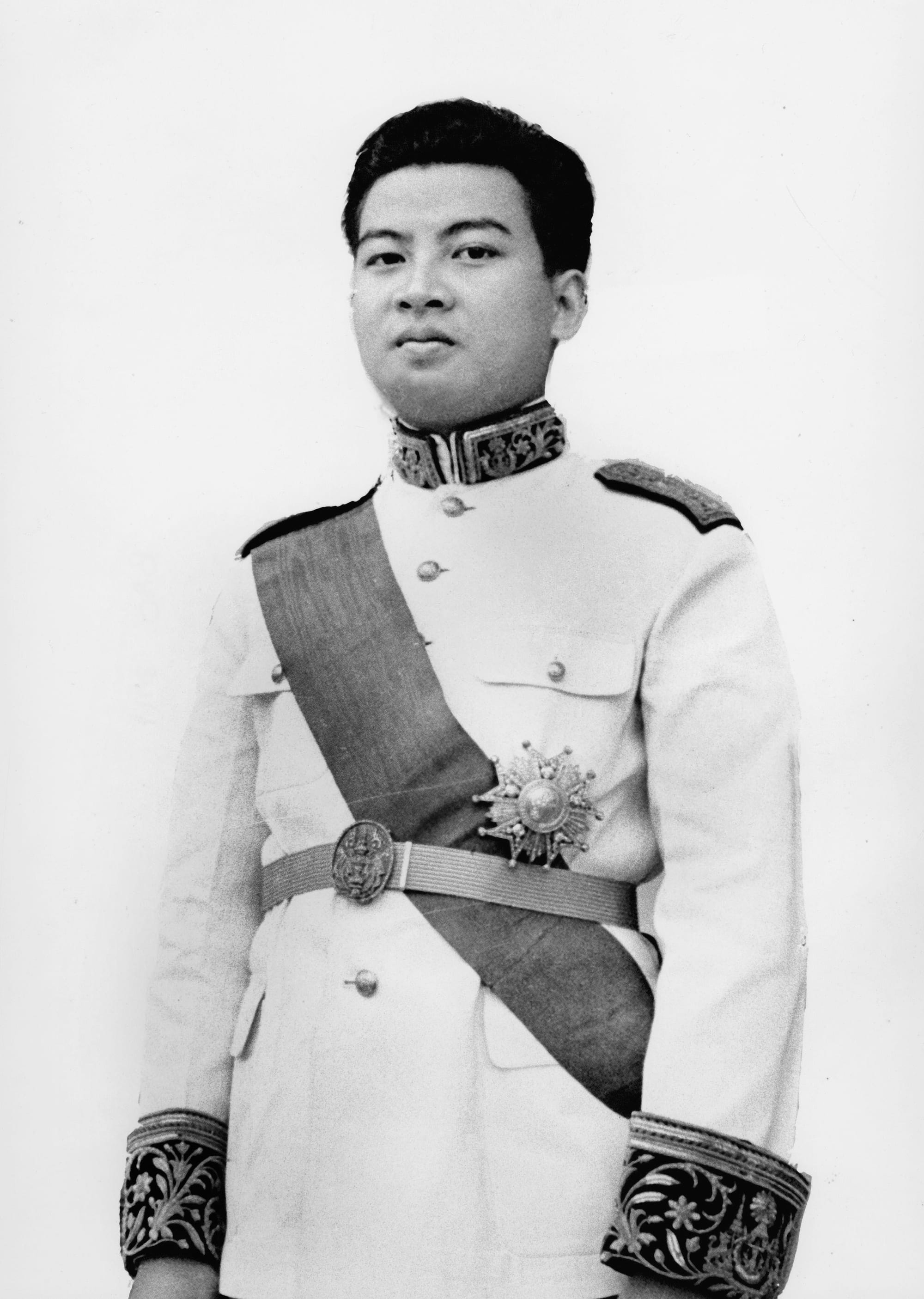 A formal 1940s portrait of a young Norodom Sihanouk in an ornate military uniform