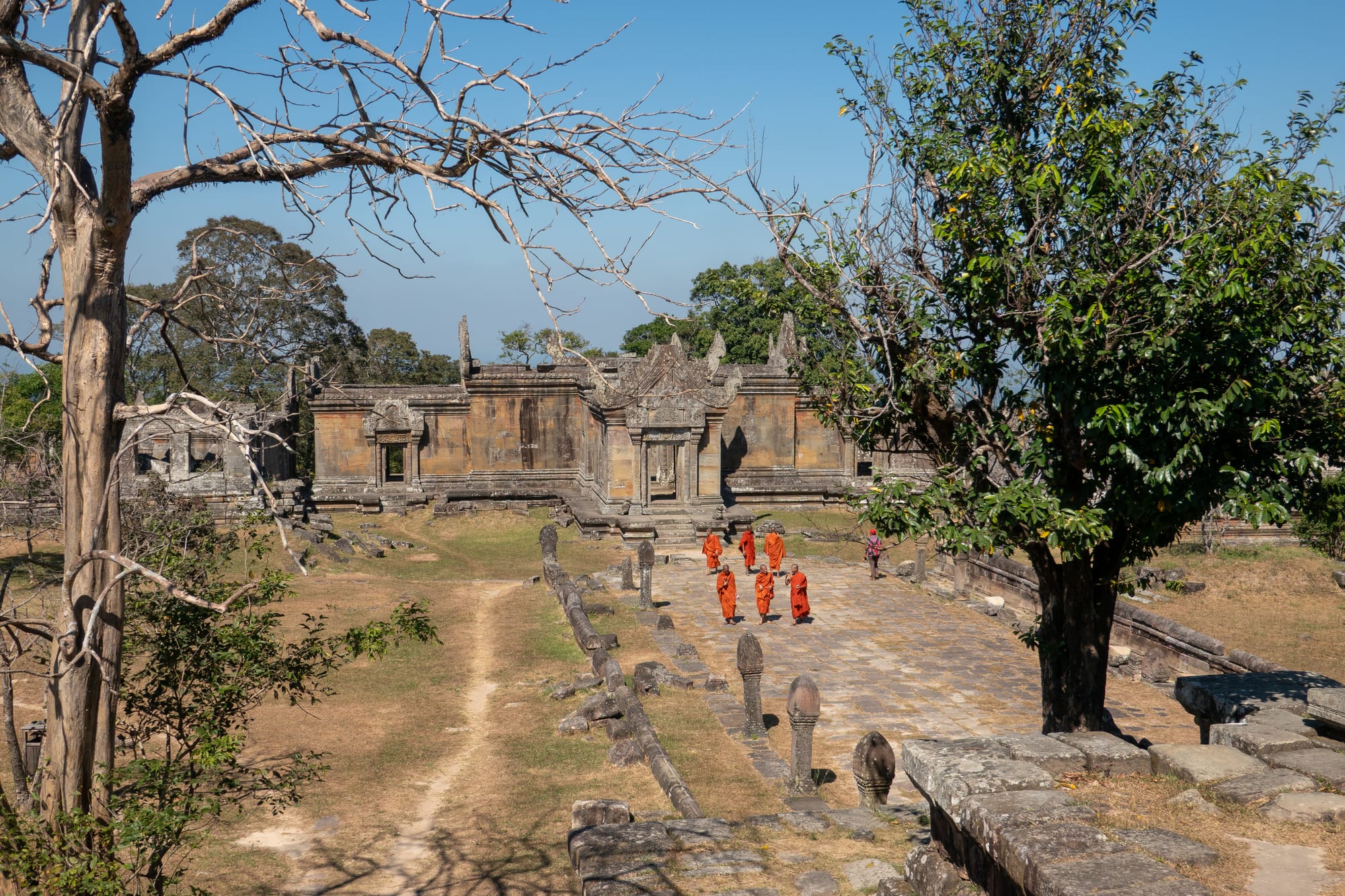 A stone temple gallery running along a narrow ridge that drops away steeply on both sides