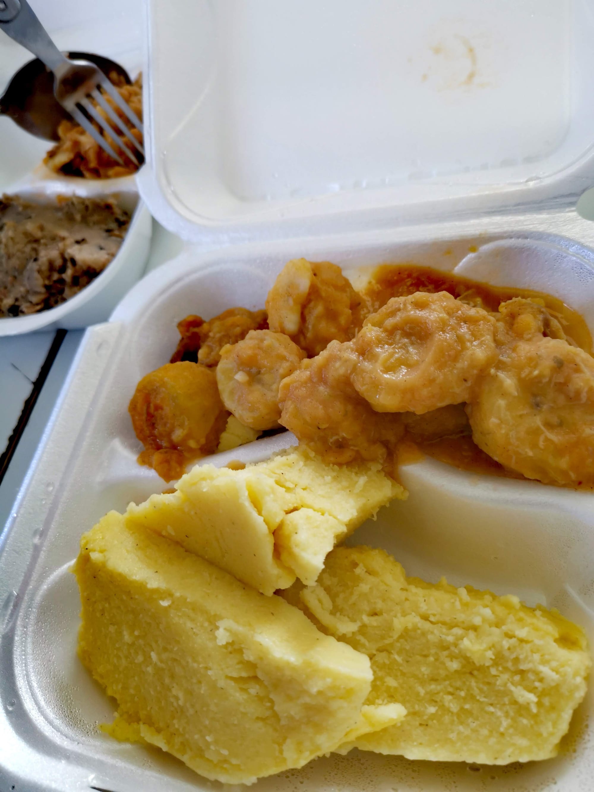 A serving of firm, pale yellow cornmeal paste