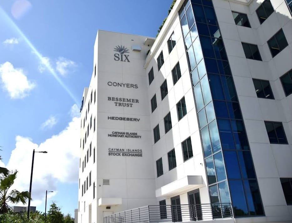 A modern office tower in George Town with signage for banks, trust companies and the Cayman Islands Monetary Authority and Stock Exchange