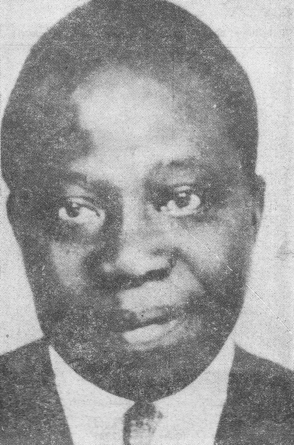 A 1958 portrait of Barthélemy Boganda in a suit and glasses, looking to the side
