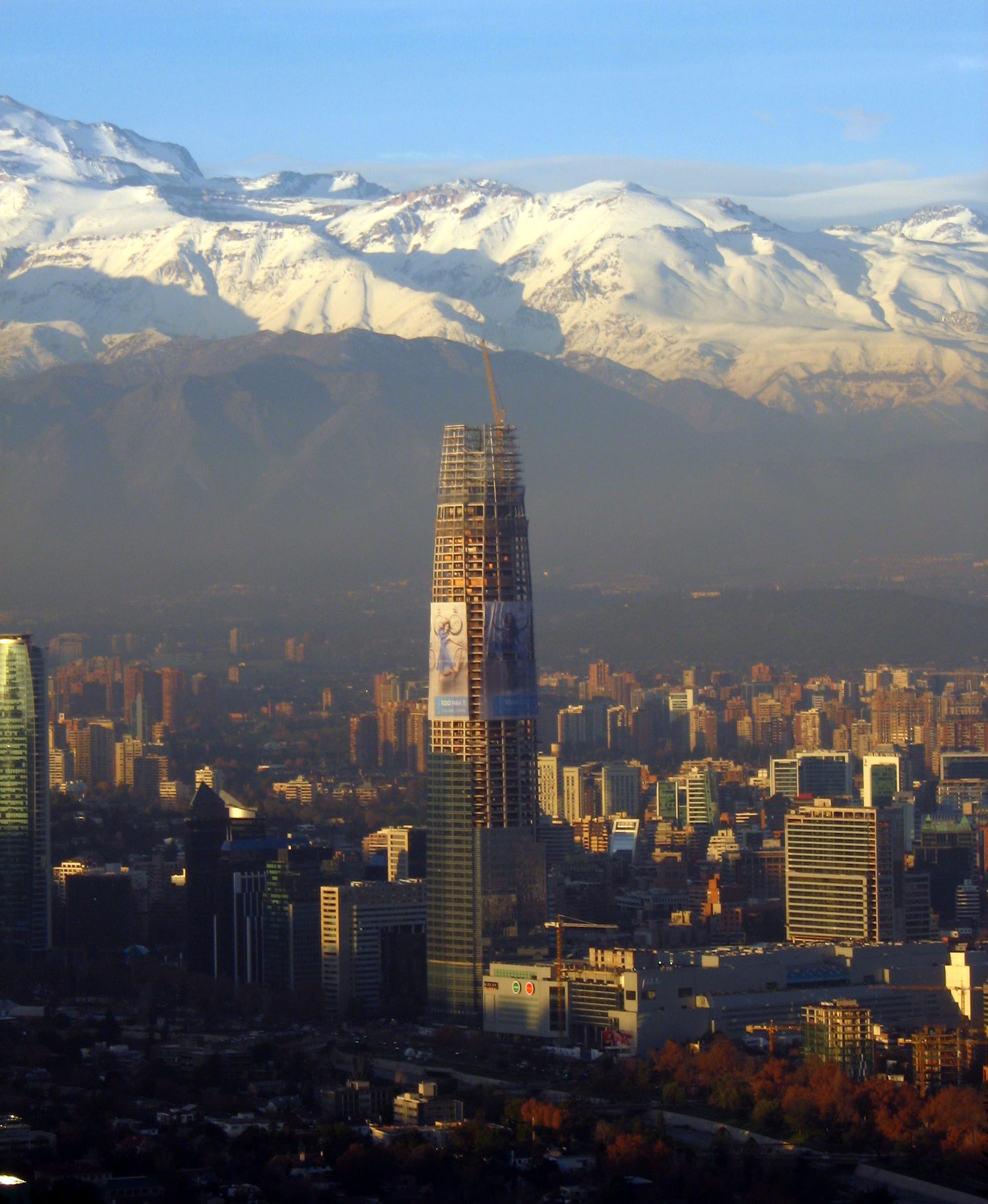 A city of towers on a plain with a wall of snow-capped Andes rising directly behind