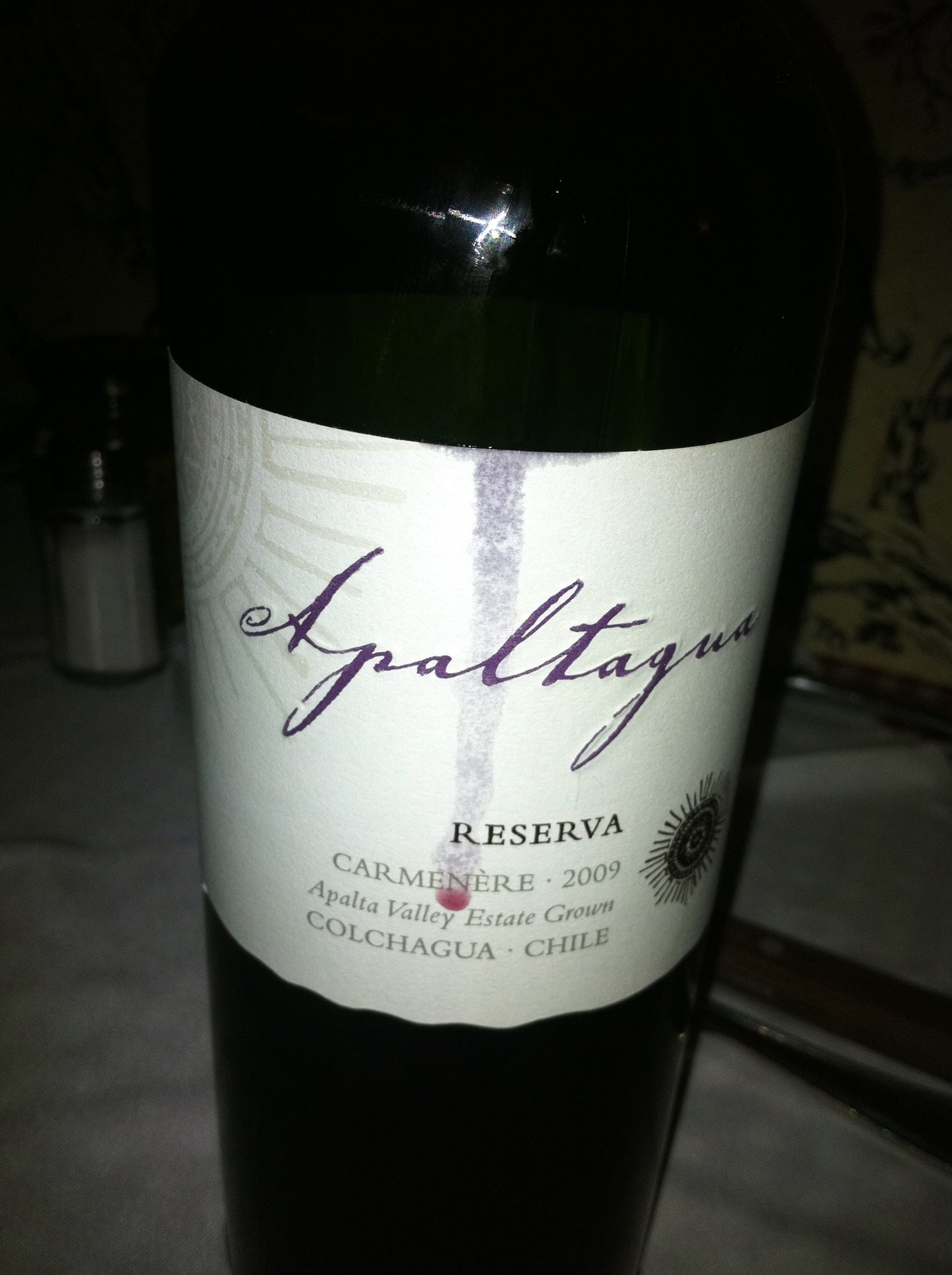 A bottle of red wine labelled Carmenere on a table in Santiago