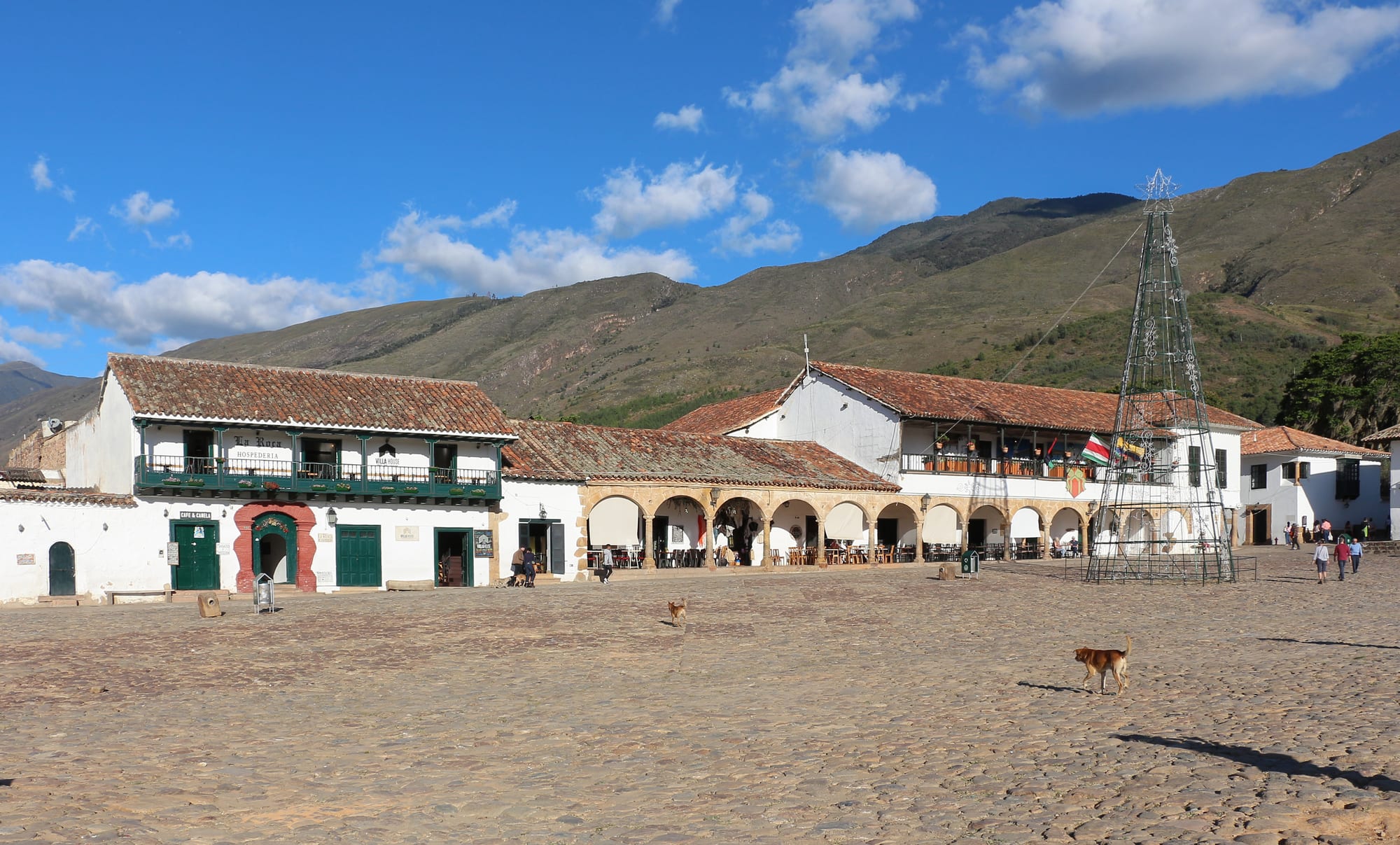An enormous cobbled square framed by low whitewashed colonial buildings and a church