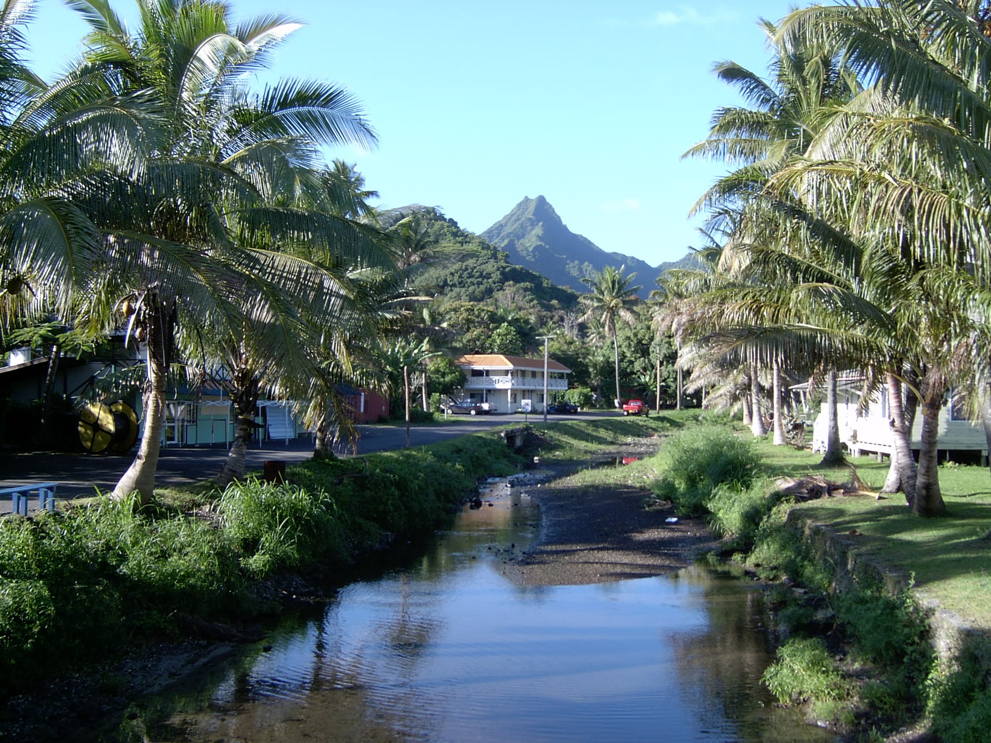 A green valley of gardens and houses rising to steep jungle-covered volcanic peaks