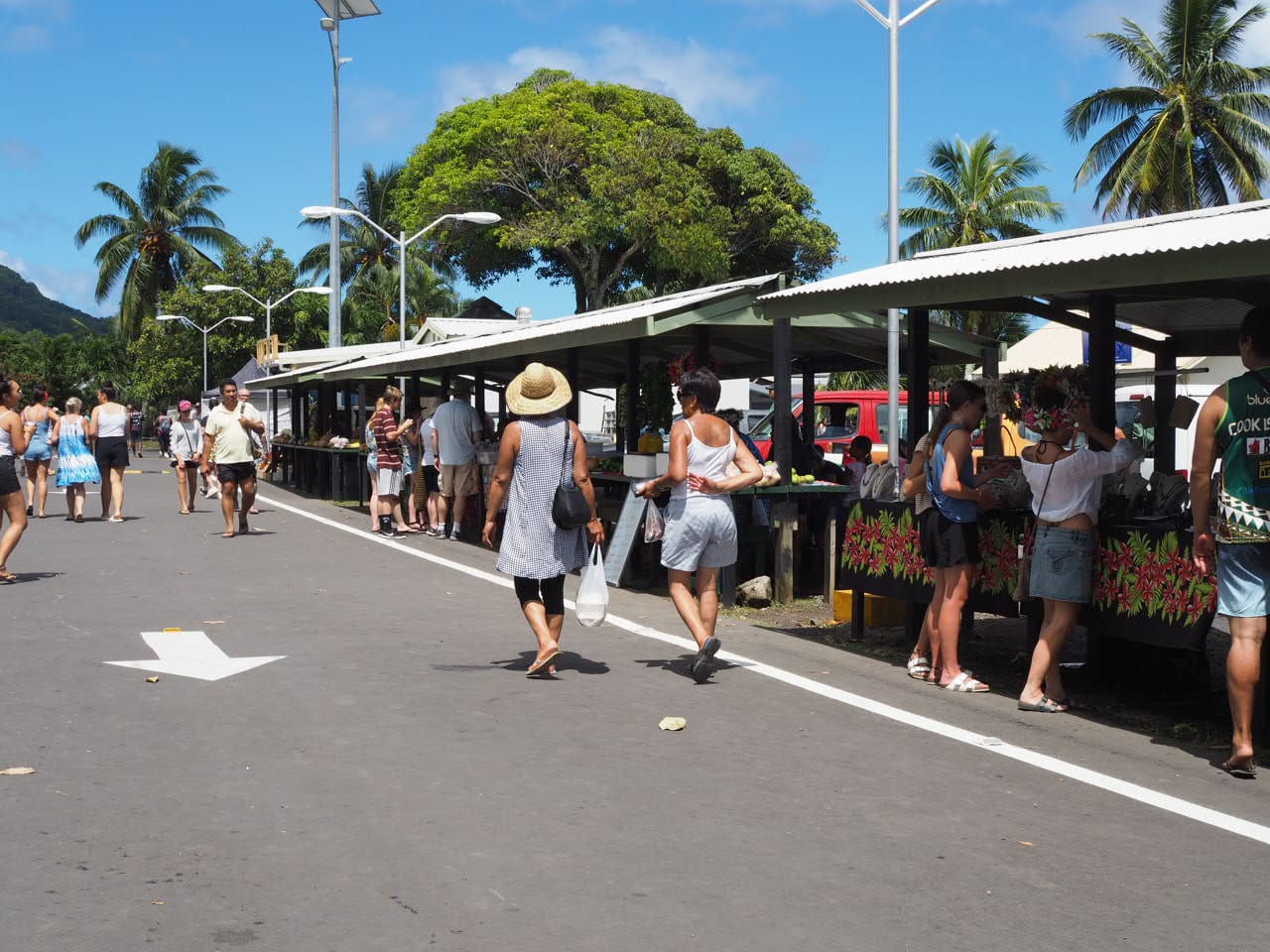 An outdoor market with stalls of local produce