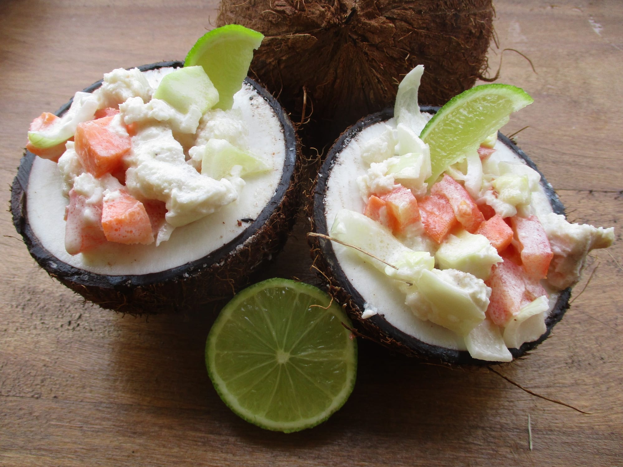 A bowl of diced raw fish mixed with chopped vegetables in a creamy dressing