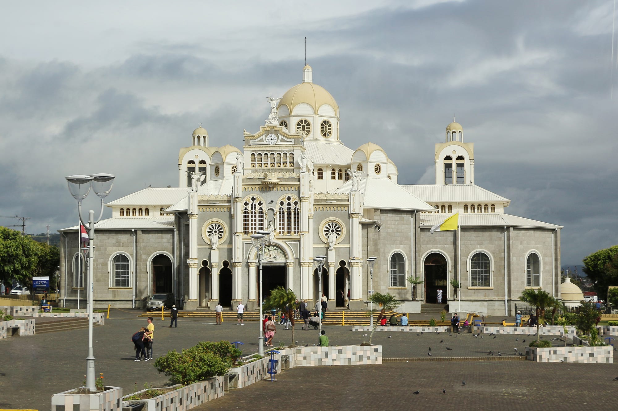 A large Byzantine-style basilica with domes and towers, floodlit against a dark sky