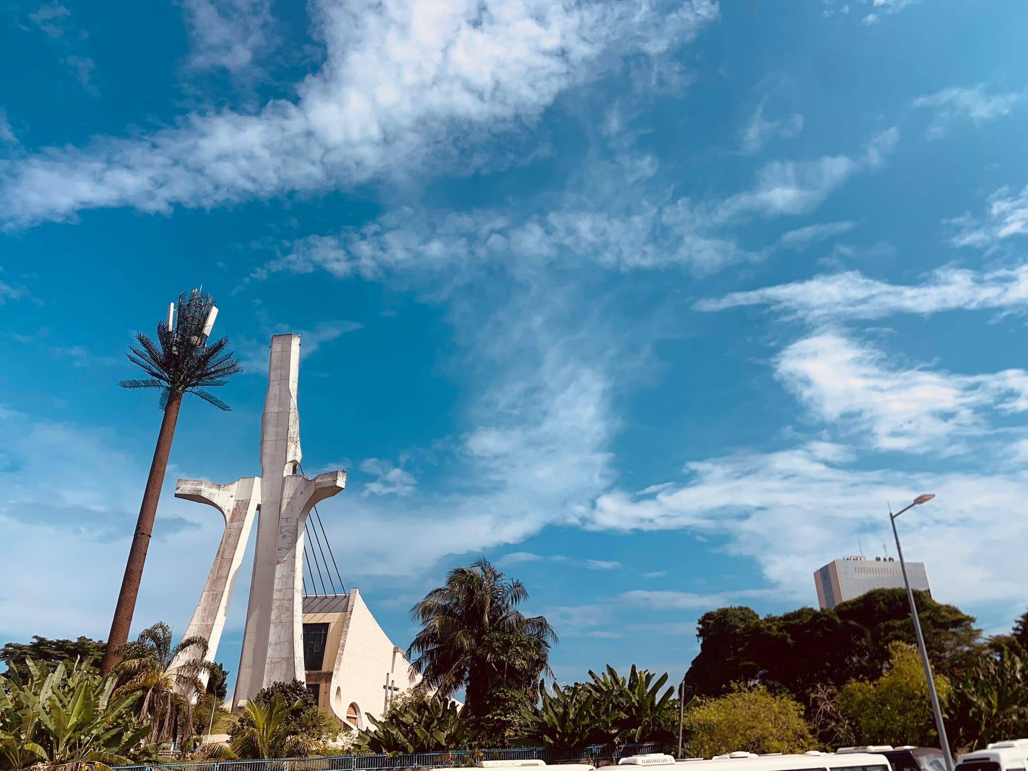 A dramatic modern cathedral shaped like a figure leaning forward, cables fanning from a mast