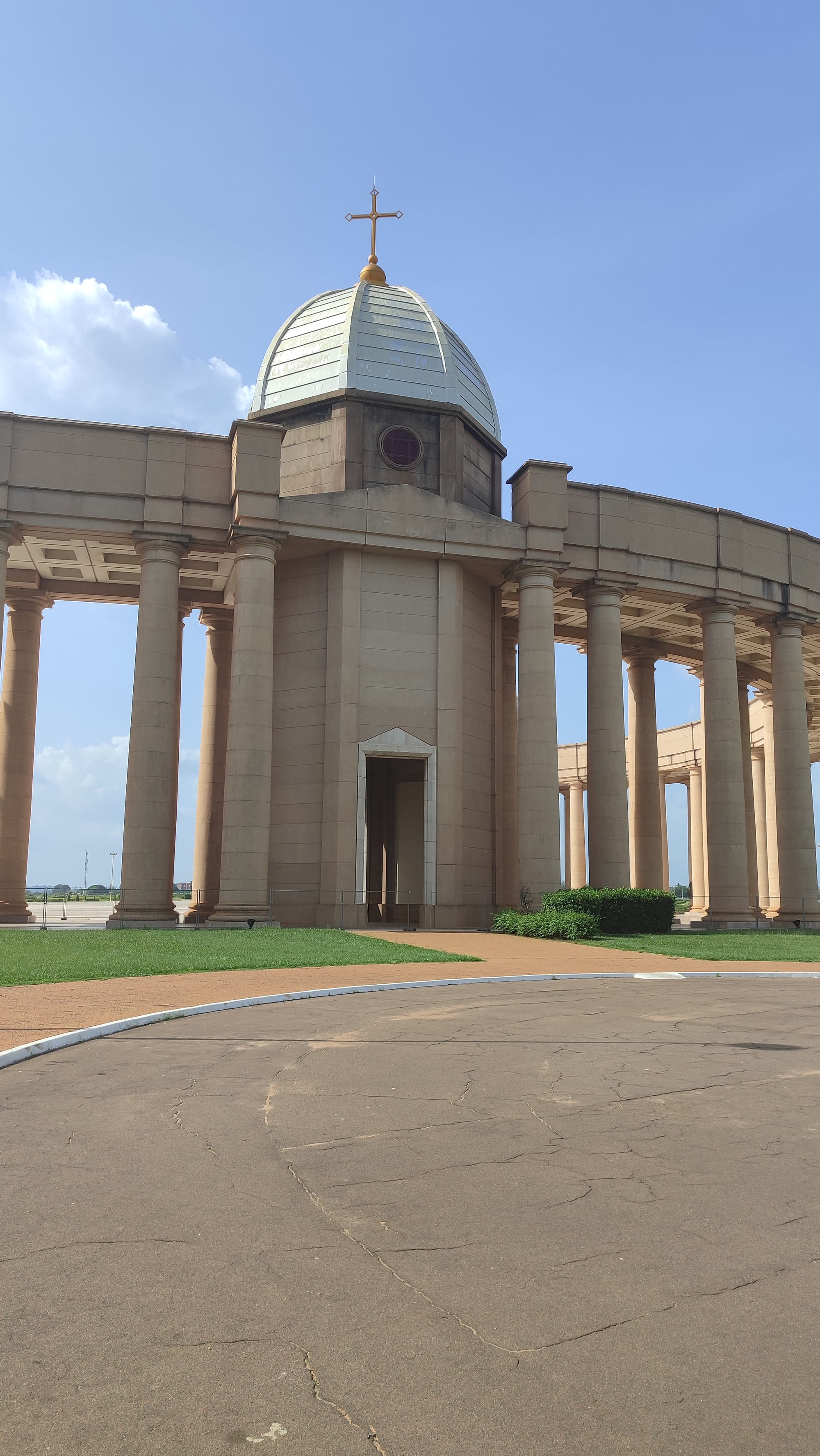 A vast domed church entrance framed by a colonnade of tall columns
