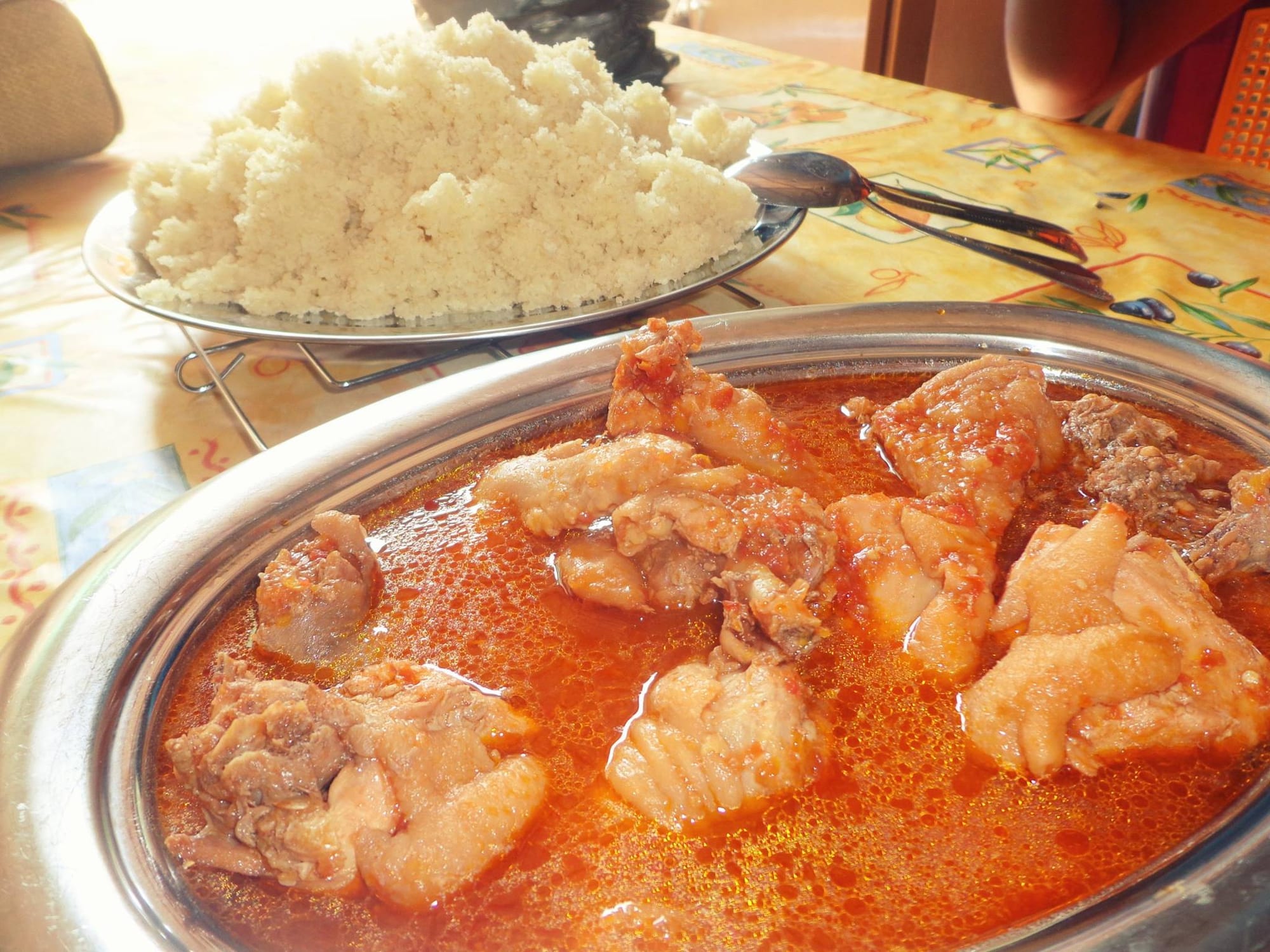 A bowl of chicken pieces in a thick, dark, well-reduced sauce with vegetables