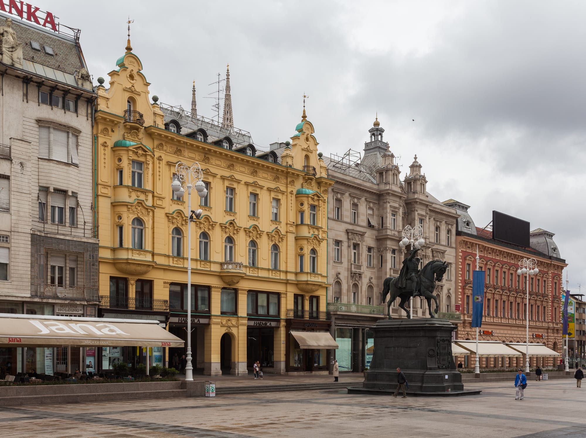 An equestrian bronze statue of a 19th-century general with a raised sword, in a large city square