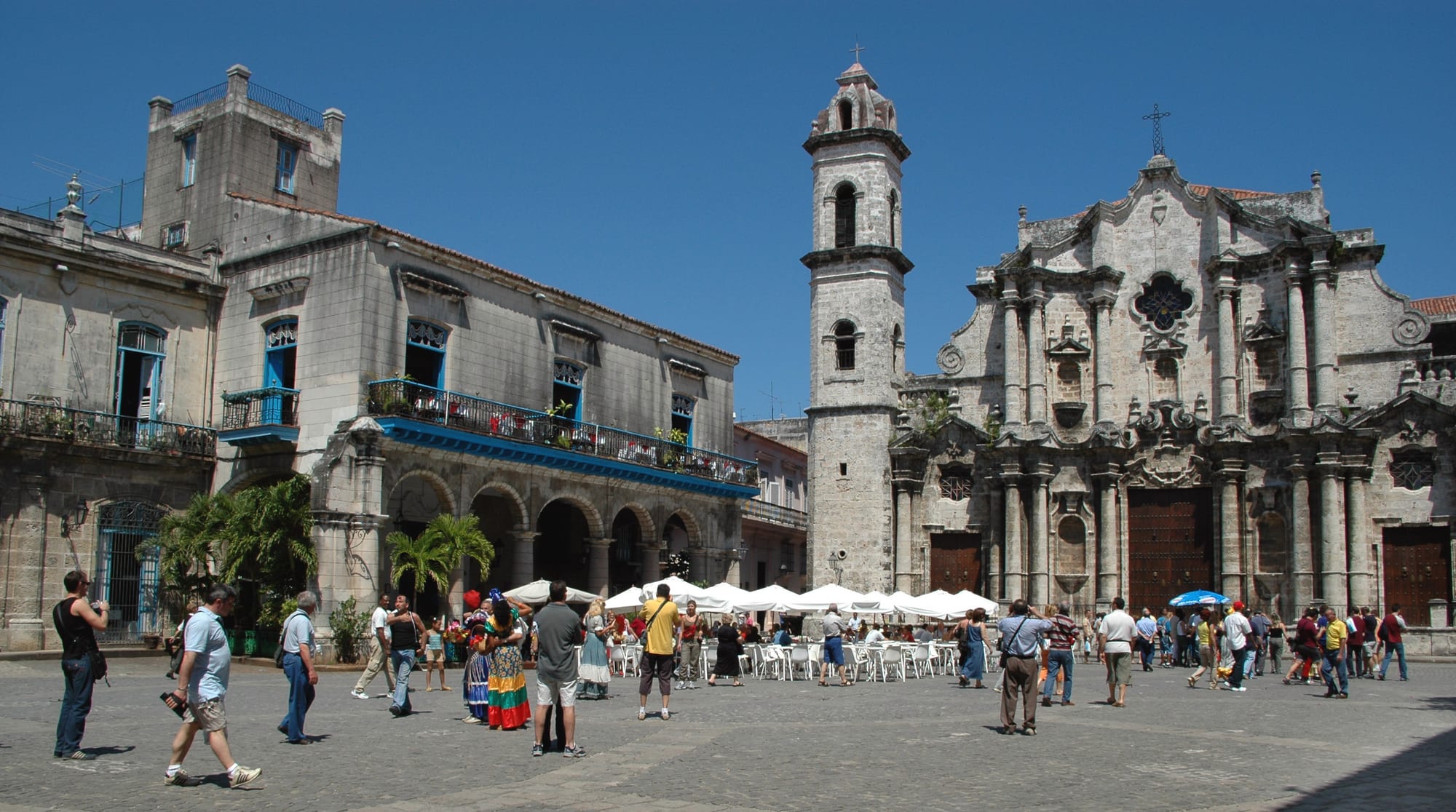 A cobbled square ringed by colonial mansions with deep arcades, a cathedral to one side