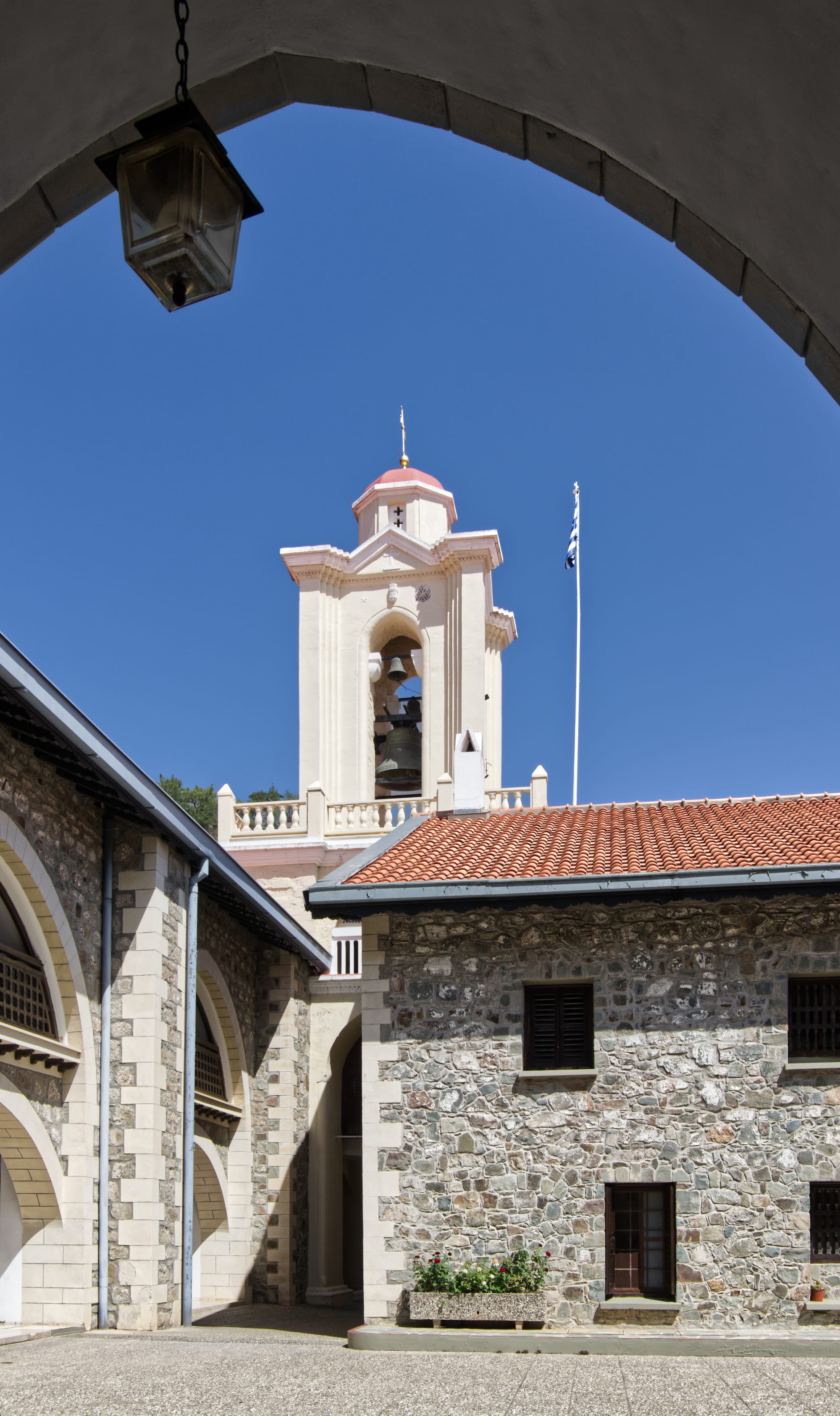 An arcaded monastery courtyard with brightly coloured mosaics and frescoes on every wall