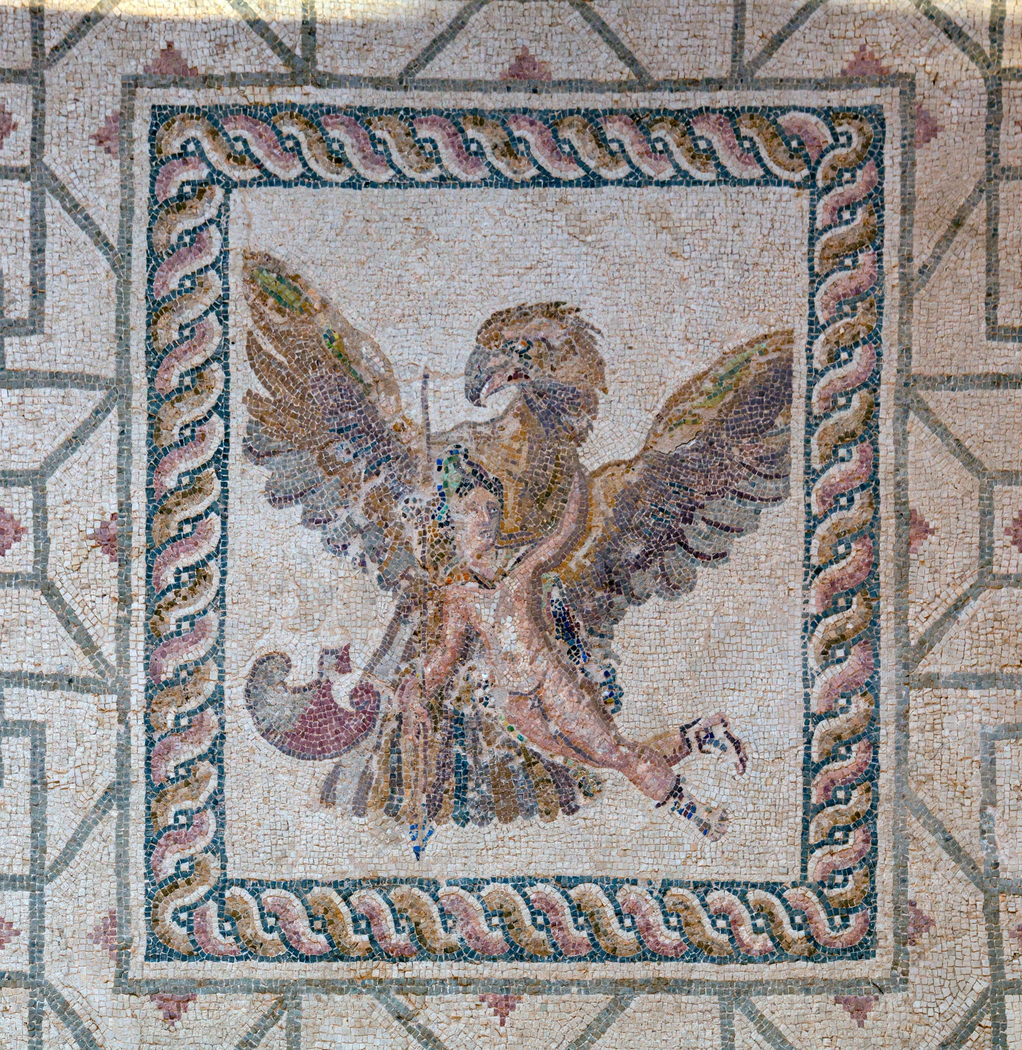 An intricate Roman floor mosaic of figures and geometric borders, under a protective shelter