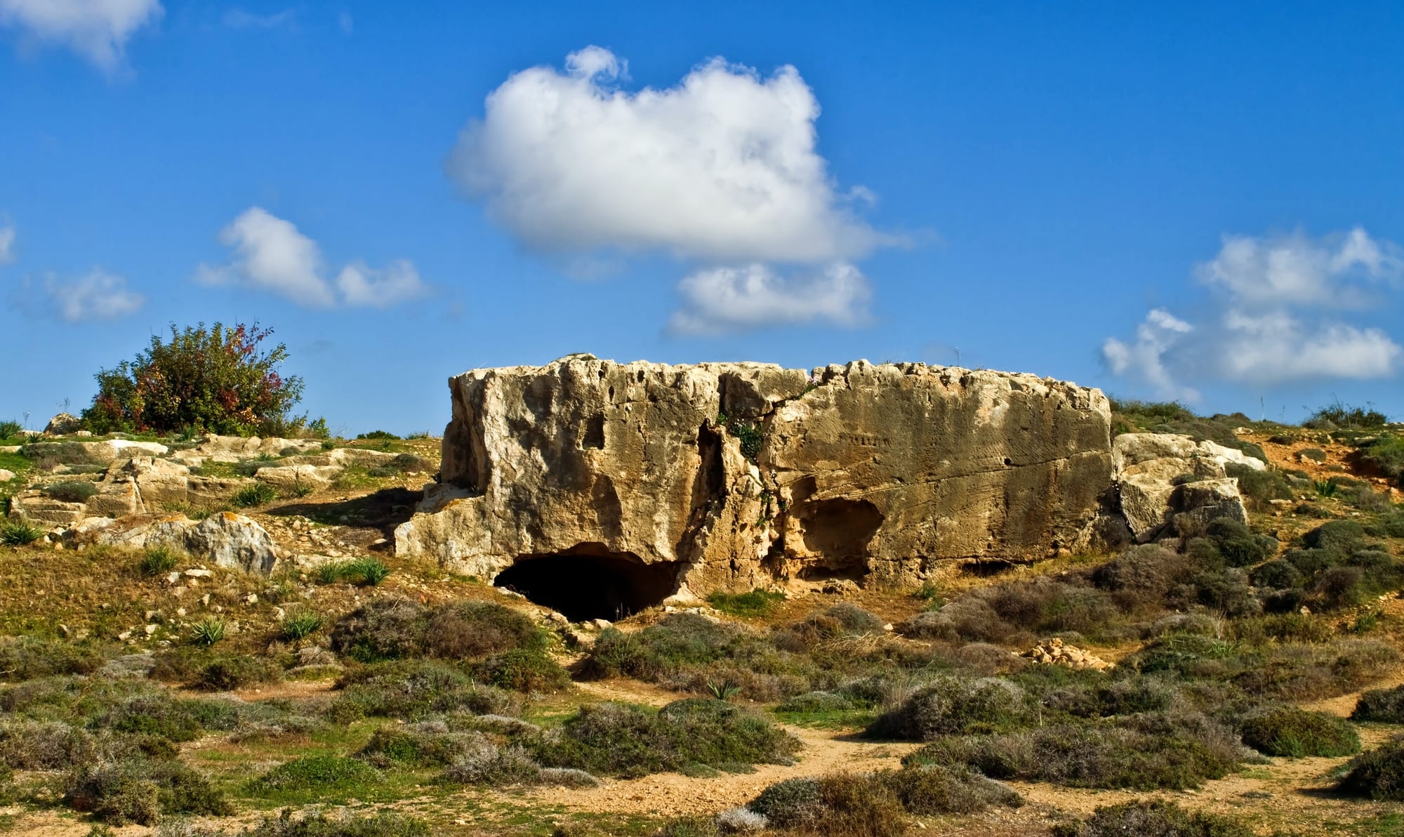 Rock-cut underground courtyards with columns carved from the stone, open to the sky