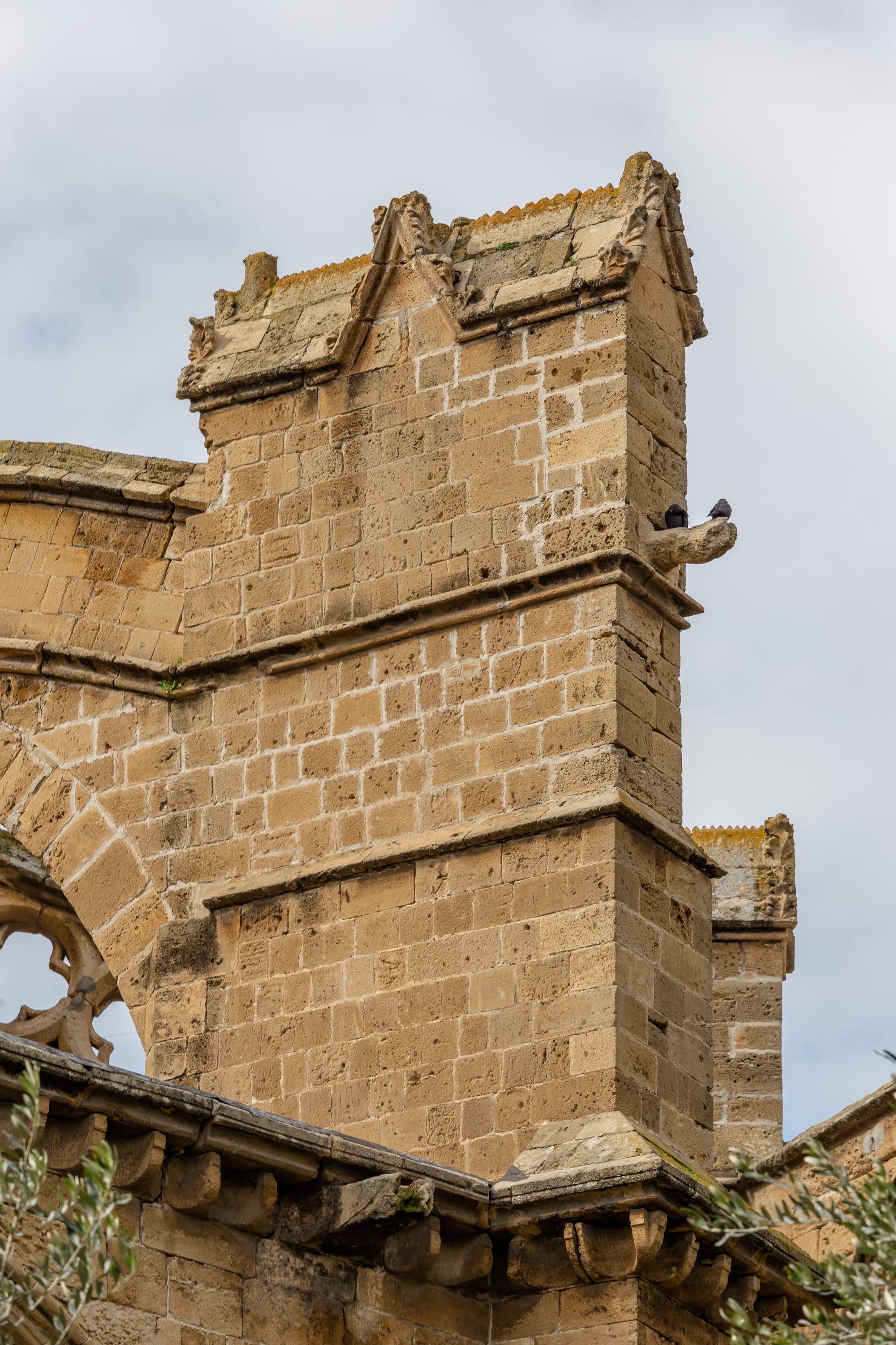 A French Gothic cathedral front with pointed arches and rose window, flanked by two tall Ottoman minarets
