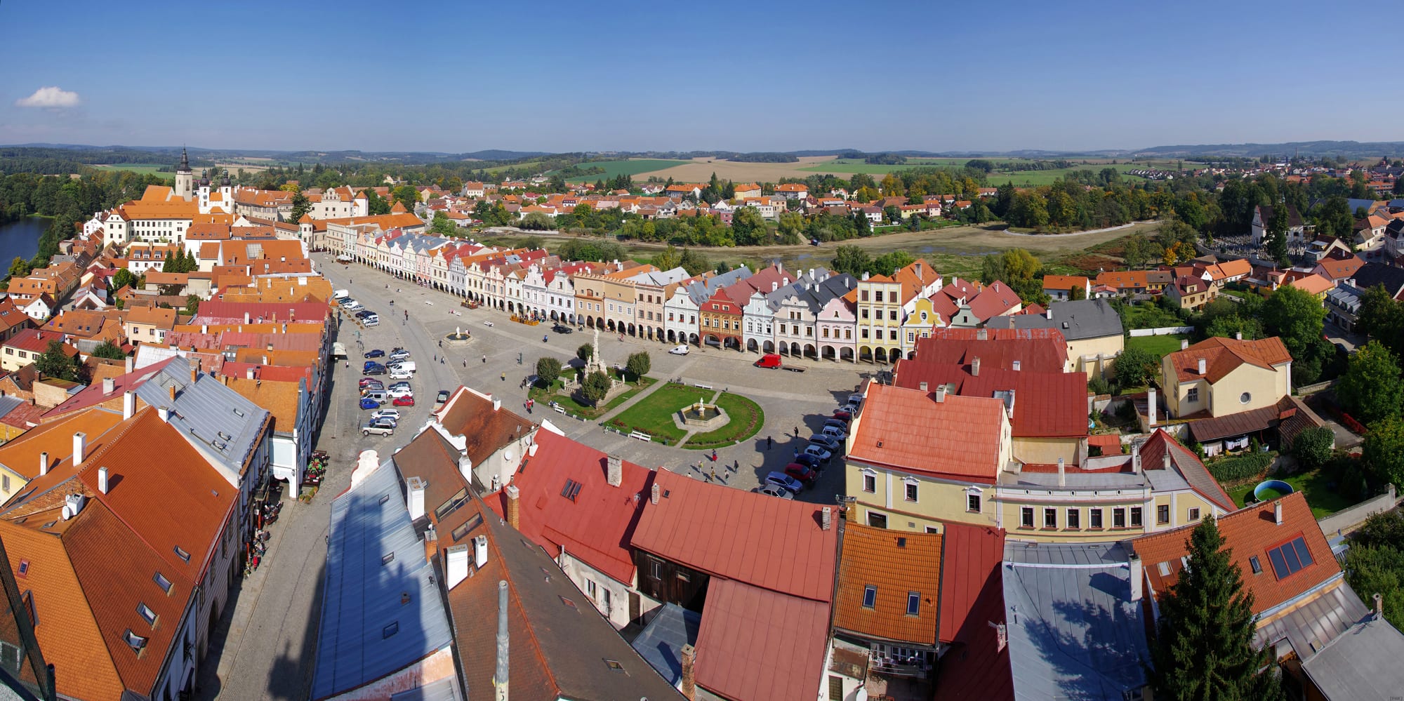 A long triangular market square framed by arcaded Renaissance houses with decorative gables, seen from above