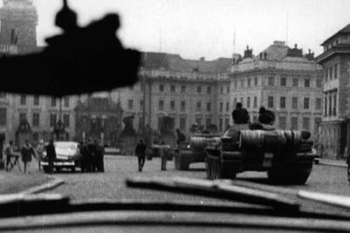 Soviet tanks parked on a Prague square in August 1968 as bystanders watch