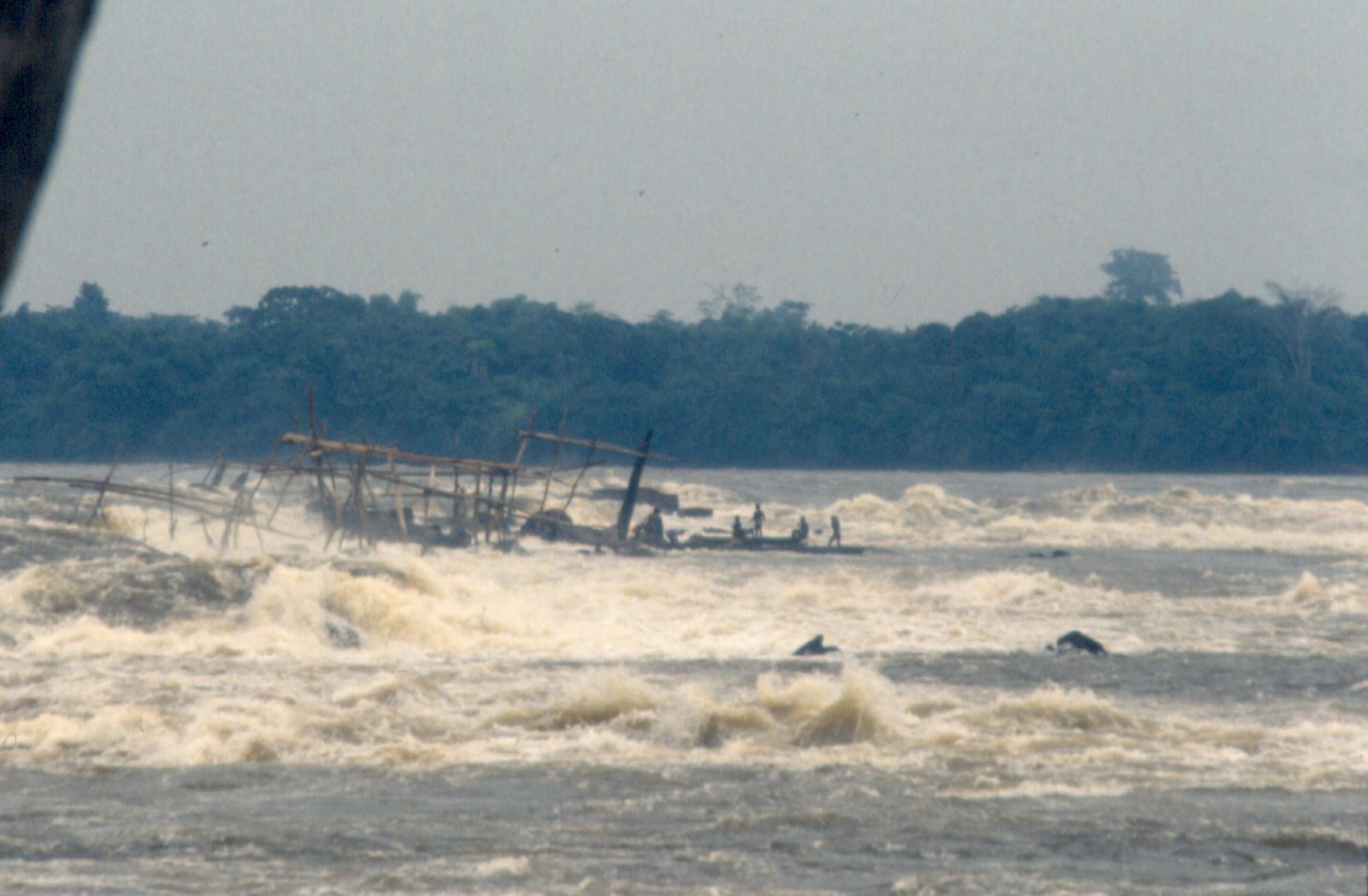 Wide, powerful river rapids churning around rocky outcrops