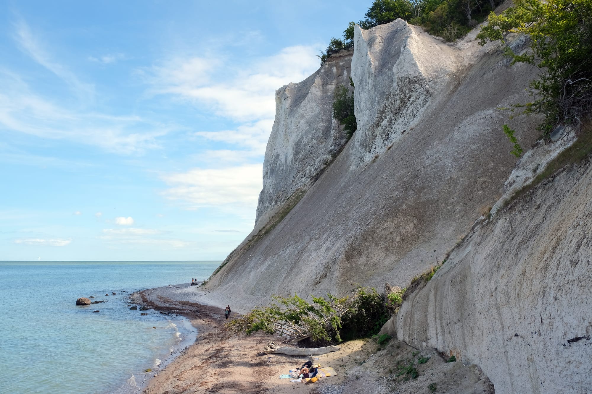 Brilliant white chalk cliffs topped with green beech woods, dropping to a turquoise sea
