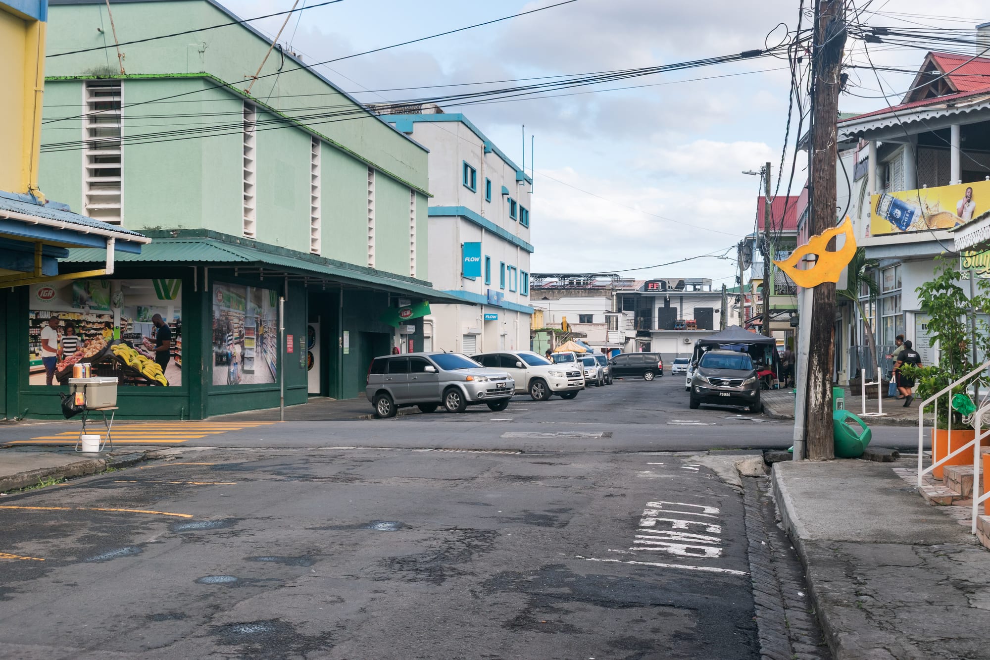A street of small colourful timber and stone Caribbean houses with overhanging balconies