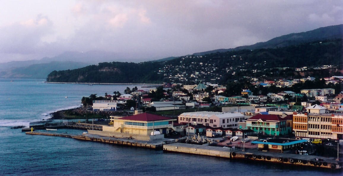 An overview of Roseau, Dominica, showing the coastal town against forested mountains